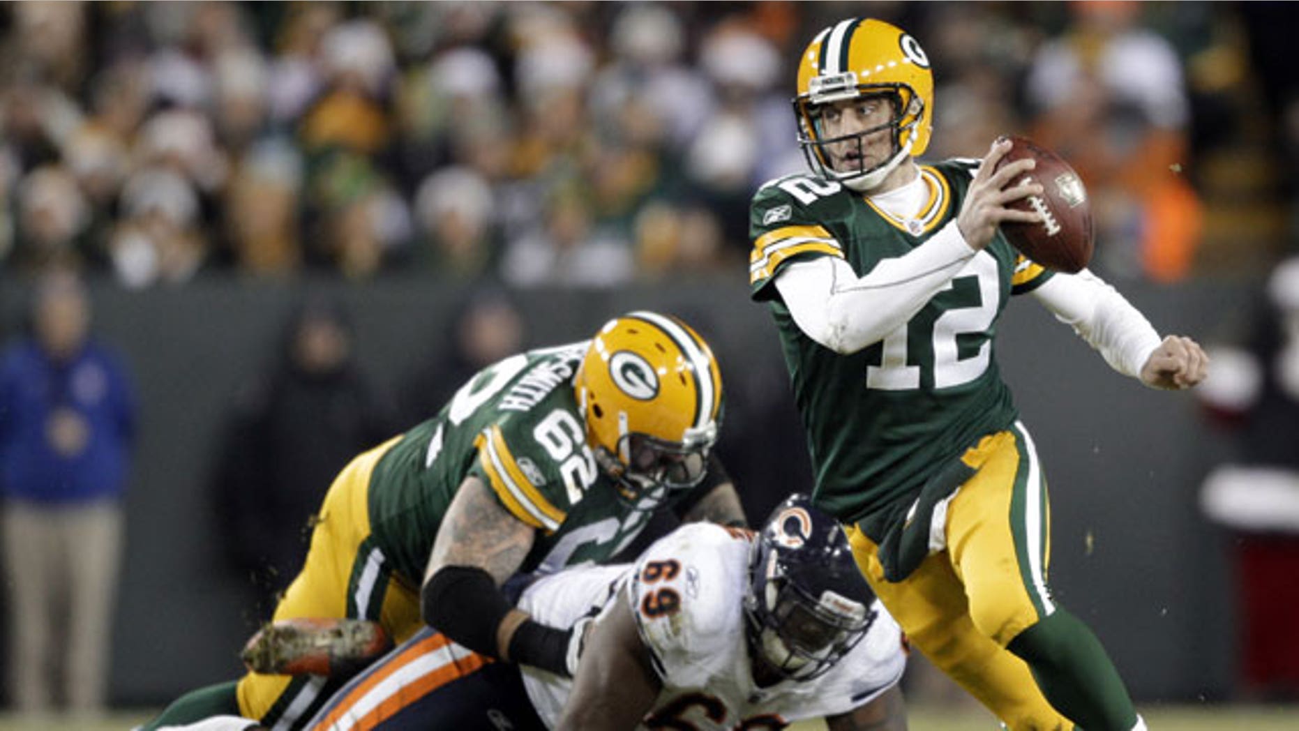 December 25, 2011: Green Bay Packers quarterback Aaron Rodgers scrambles during the second half of an NFL football game against the Chicago Bears in Green Bay, Wis.