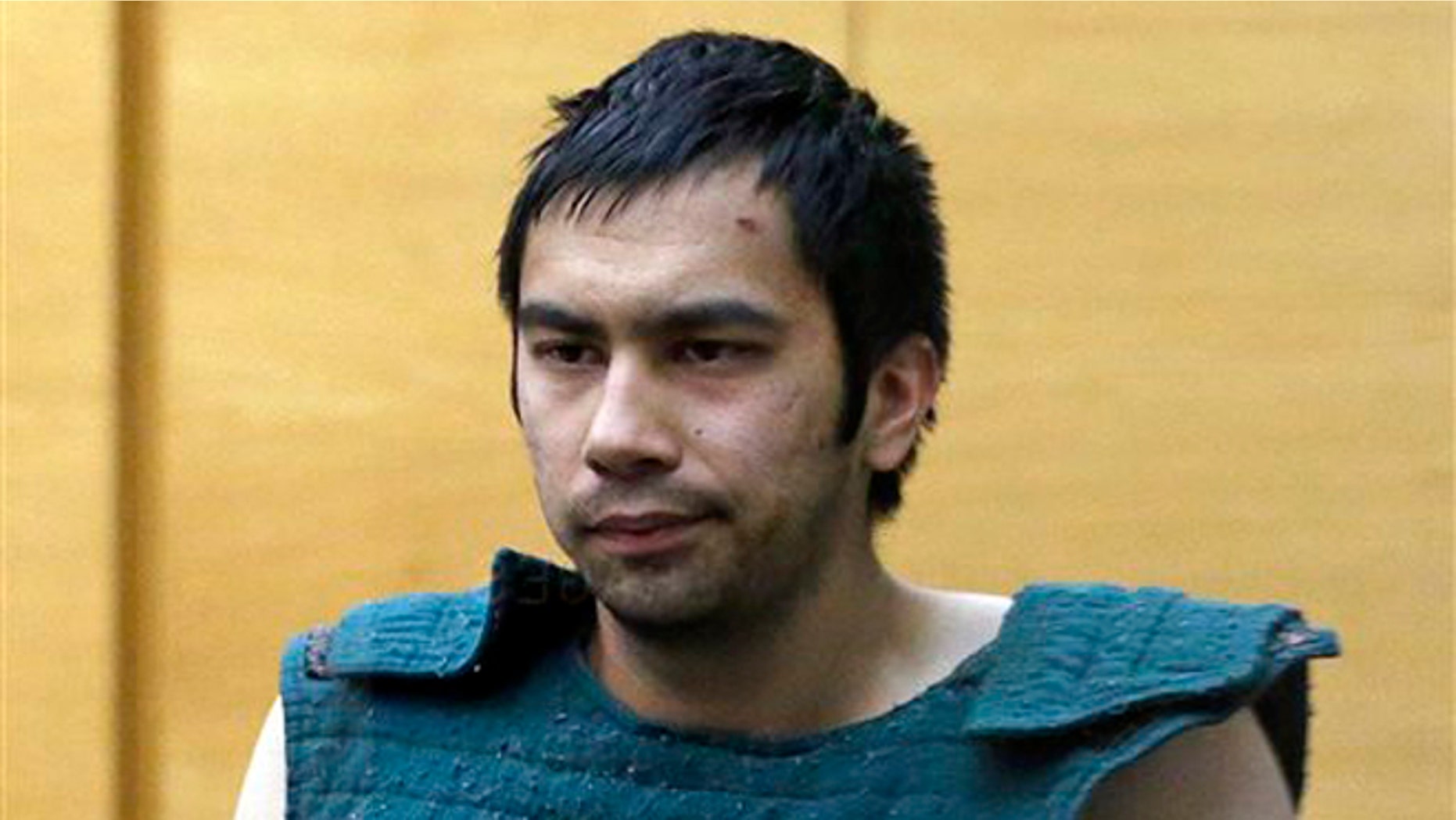Shooting suspect Aaron Ybarra is led to a court hearing at a King County Jail courtroom Friday, June 6, 2014, in Seattle. Ybarra was arrested in the killing of a 19-year-old student and wounding of two other young people Thursday at Seattle Pacific University. Police say Jon Meis and other students subdued Ybarra until officers arrived and handcuffed him moments later. Meis, the 22-year-old building monitor, pepper-sprayed and tackled the gunman Thursday in Seattle Pacific University's Otto Miller Hall, likely preventing further carnage, according to police and university officials. (AP Photo/Elaine Thompson)