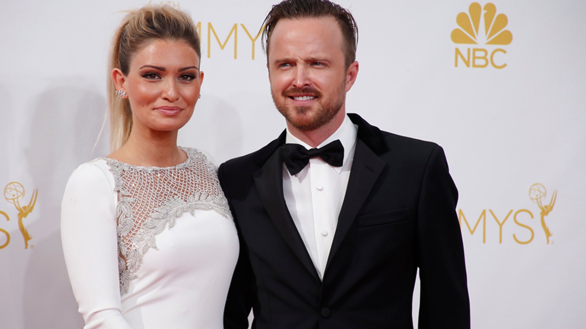 Aaron Paul from the AMC series "Breaking Bad" and his wife, Lauren Parsekian, arrive at the 66th Primetime Emmy Awards in Los Angeles, California August 25, 2014.