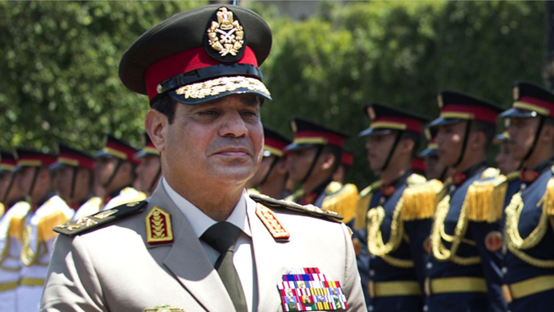 April 24, 2013: In this file photo, Egyptian Defense Minister Gen. Abdel-Fattah el-Sissi reviews honor guards during an arrival ceremony for his U.S. counterpart at the Ministry of Defense in Cairo. Egypt's military chief says he "can't turn his back" if the majority of Egyptians want him to run for president.