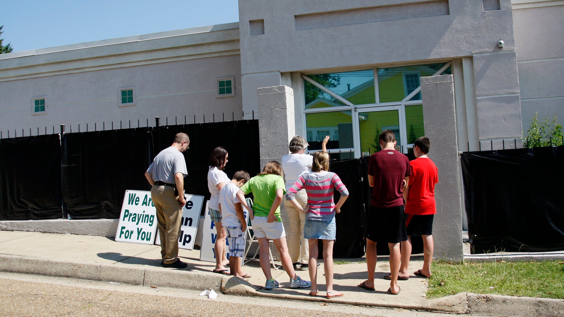 June 27, 2012: In this photograph, anti-abortion advocates stand outside Mississippi's only abortion clinic, singing and praying for their patients, and "counseling" them to reject abortion.