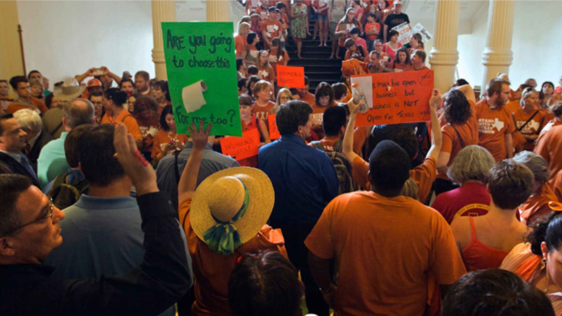 June 23, 2013: A large crowd, many wearing Planned Parenthood T-shirts that read “Stand with Texas Woman,” gather at the Texas State Capitol in Austin, Texas.