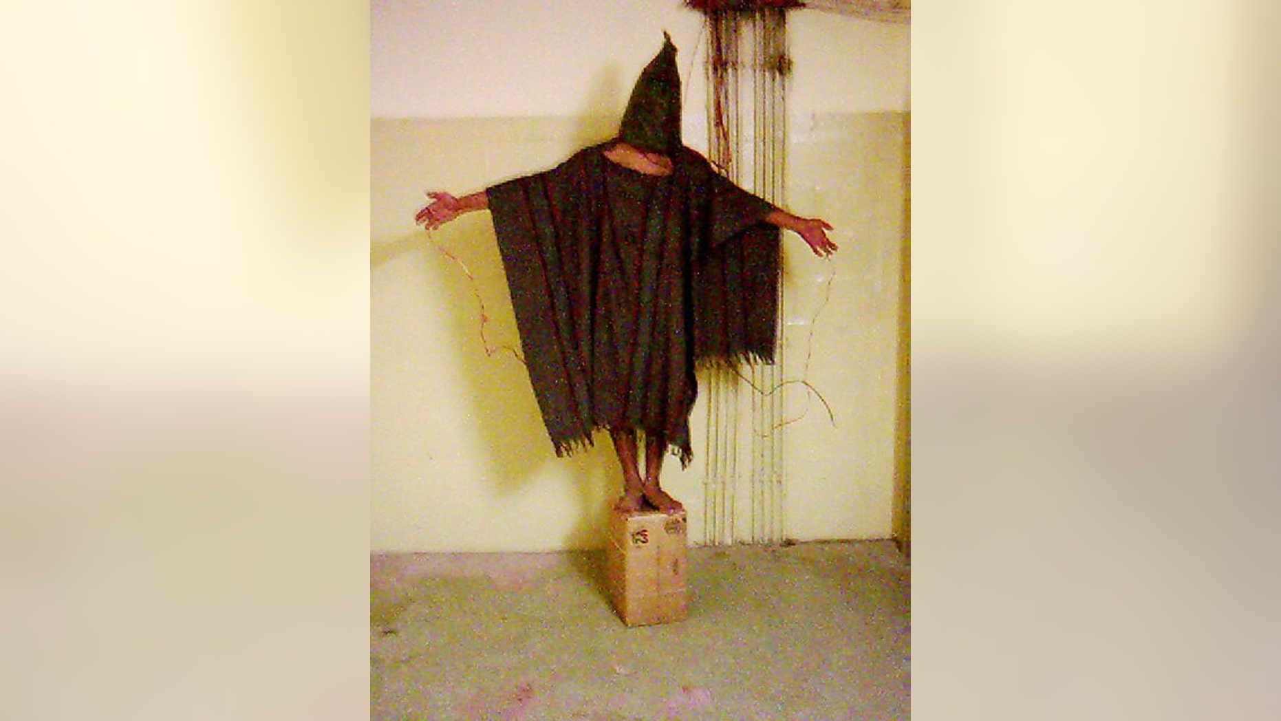 FILE - This late 2003 file image obtained by The Associated Press shows an unidentified detainee standing on a box with a bag on his head and wires attached to him at the Abu Ghraib prison in Baghdad, Iraq. A federal judge ruled Friday, March 20, 2015, that the U.S. must release photographs showing abuse of detainees in Iraq and Afghanistan, following a long-running clash over letting the world see potentially disturbing images of how the military treated prisoners. (AP Photo/File)