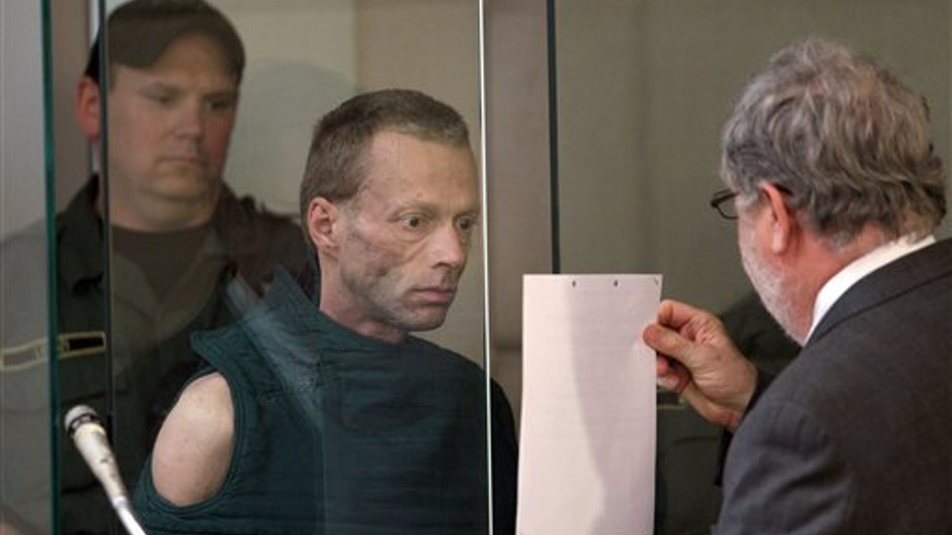 July 2: Adam Lee Brown, 49, center, appears in Multnomah County Circuit Court in Portland, Ore., to face charges of kidnapping, attempted murder and assault for an alleged attack on a 10-year-old boy at a fast food restaurant on Sunday.