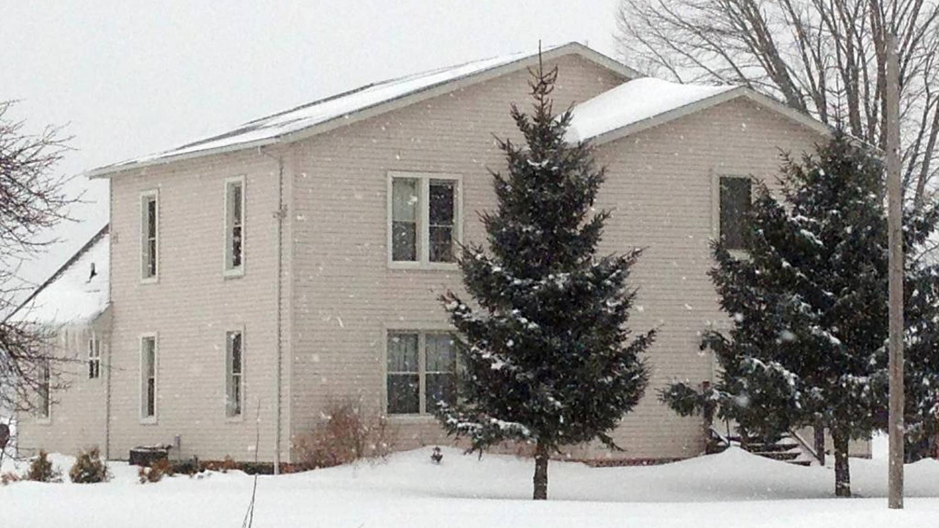 The house where a husband and wife lived with their four adopted children is shown, Wednesday, March 4, 2015, in Ashtabula, Ohio. The husband and wife pleaded not guilty to charges alleging they kept three adopted children locked in bedrooms most of the time and gave them little to eat. Prosecutors in Ashtabula County say the pair beat their two girls and their mentally challenged adult son. They were indicted last week on other charges. Prosecutors say the abuse occurred between September 2011 and September 2013. (AP Photo/Mark Gillispie)