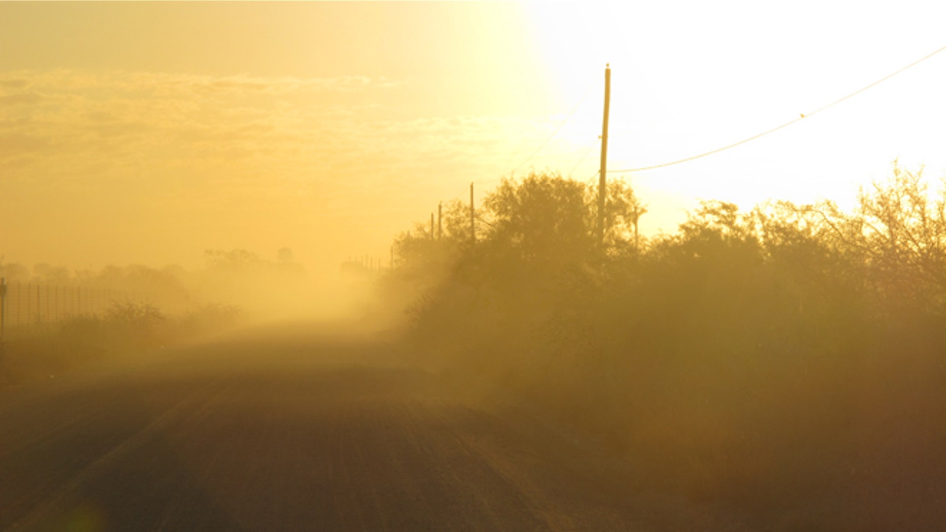 Oct. 26, 2012: The sun rises along the stretch of gravel road near La Joya, Texas, where a Texas Department of Public Safety helicopter and sharpshooter assisted the previous day in the chase of a suspected undocumented immigrant smuggler.
