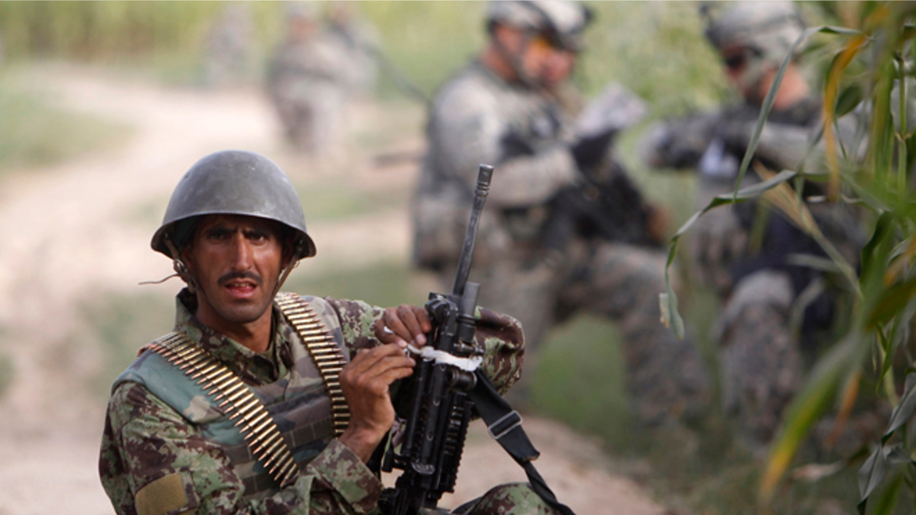 Sept. 13, 2010: An Afghan army soldier takes up position during a joint patrol with U.S. army soldiers.