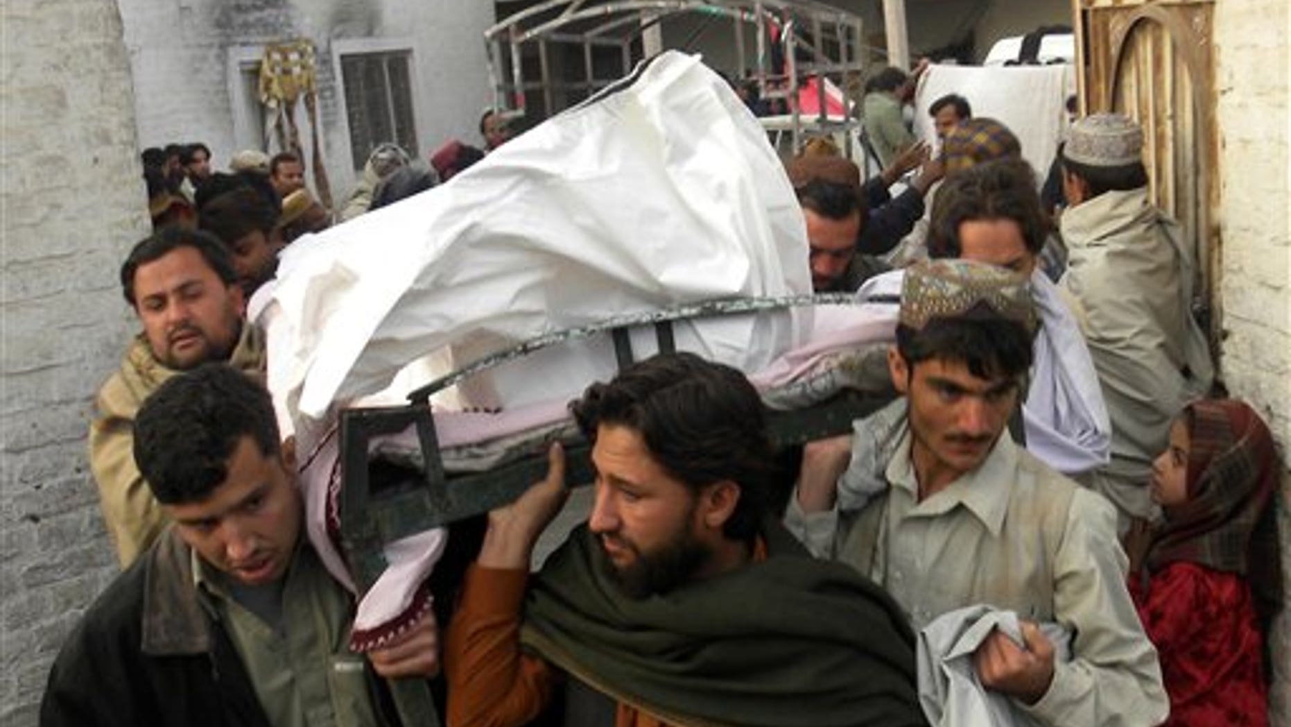 Jan. 7, 2011: People carry a dead body of Pakistani national killed in a suicide attack in neighboring Spin Boldak, Afghanistan, at a local hospital in Pakistani border town of Chaman. A suicide bomber struck a bath house in a southern Afghan border town as men gathered to wash before Friday prayers, killing a number of people, a provincial official said. The Taliban claimed responsibility, saying they targeted the deputy of an influential border patrol commander.