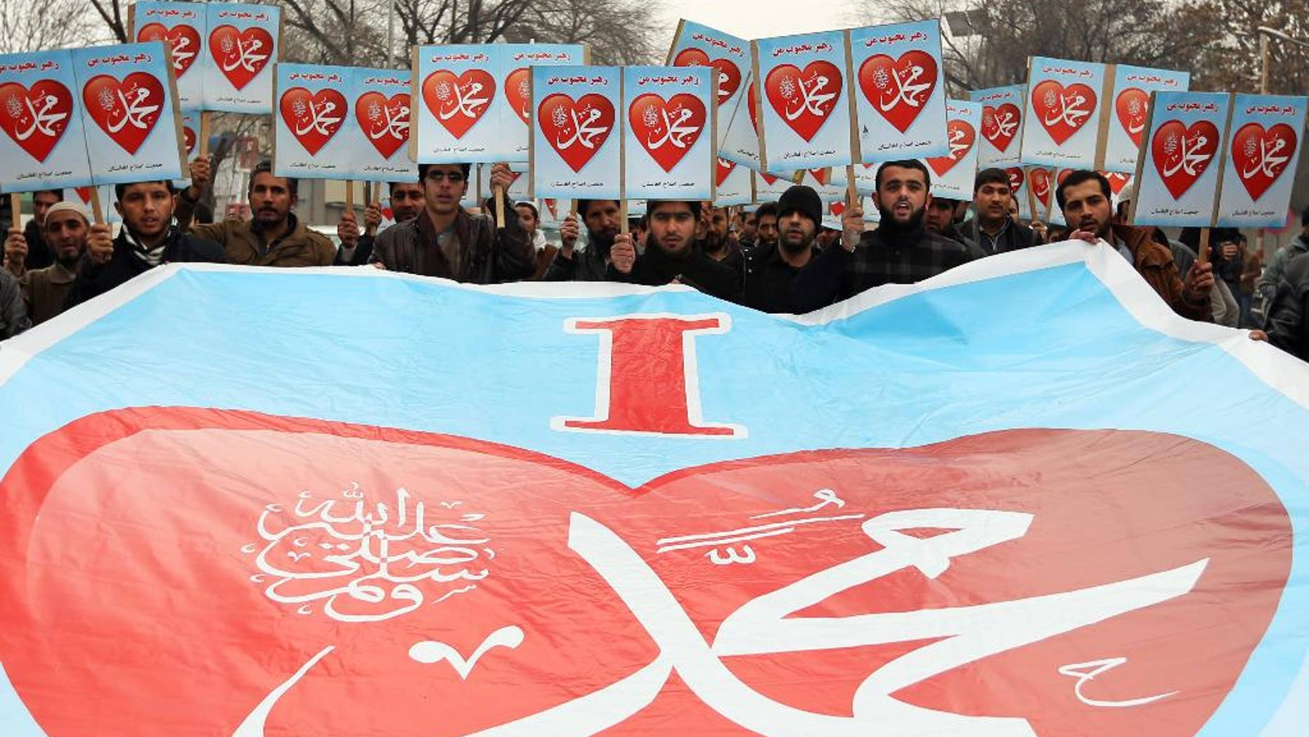 Afghans hold posters that read, "I love Muhammad," during a protest against caricatures published in French magazine Charlie Hebdo outside the French Embassy, in Kabul, Afghanistan, Thursday, Jan. 22, 2015. Around 100 people have demonstrated in the Afghan capital against the publishers of the French satirical magazine Charlie Hebdo, accusing them of blasphemy. (AP Photo/Rahmat Gul)