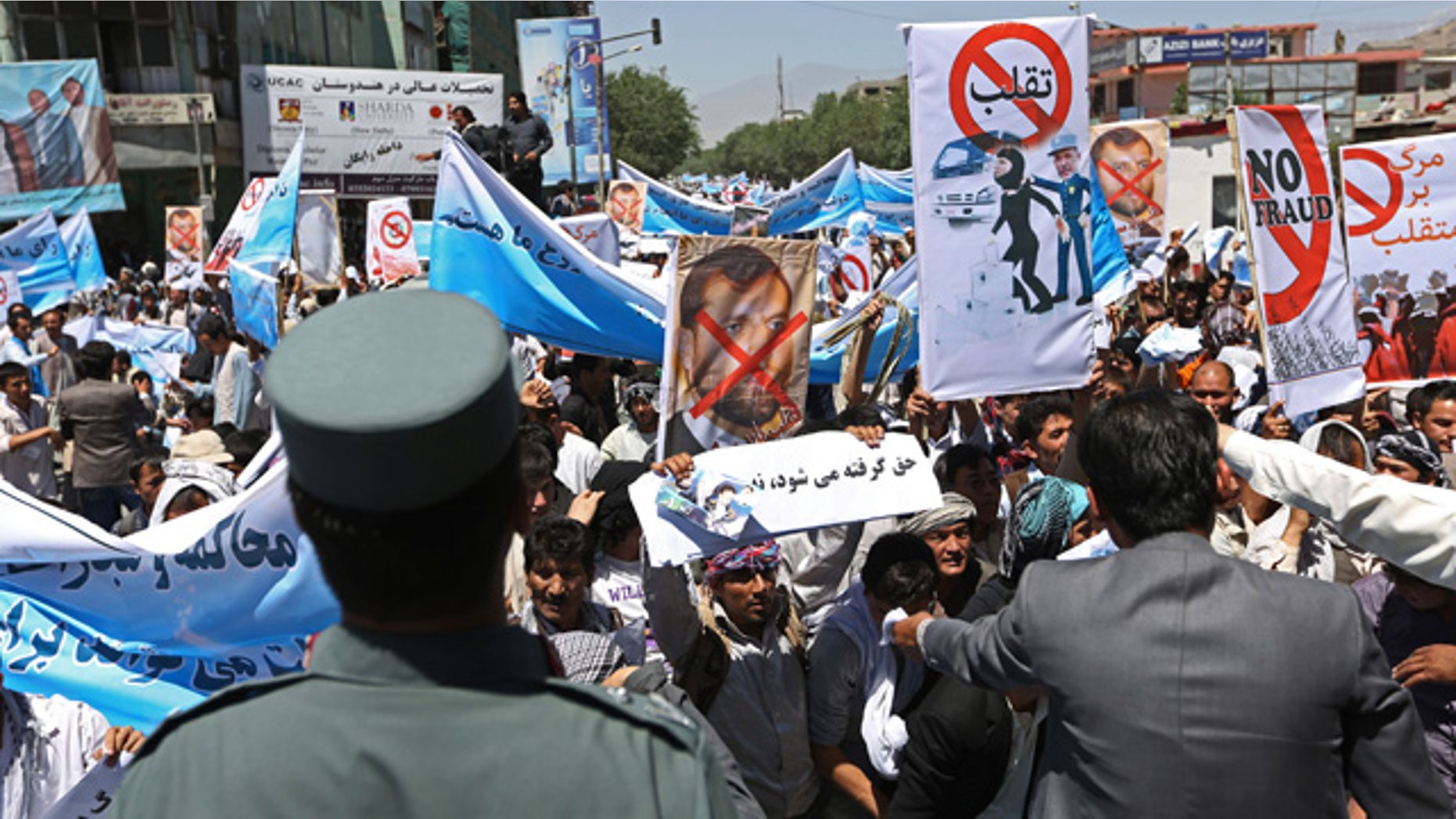 June 21, 2014: Supporters of presidential candidate Abdullah Abdullah shout slogans during a protest in Kabul, Afghanistan. Former Foreign Minister Abdullah, who is running against Ashraf Ghani Ahmadzai, a former finance minister, has accused electoral officials and others of trying to rig the June 14 vote against him. (AP Photo/Rahmat Gul)