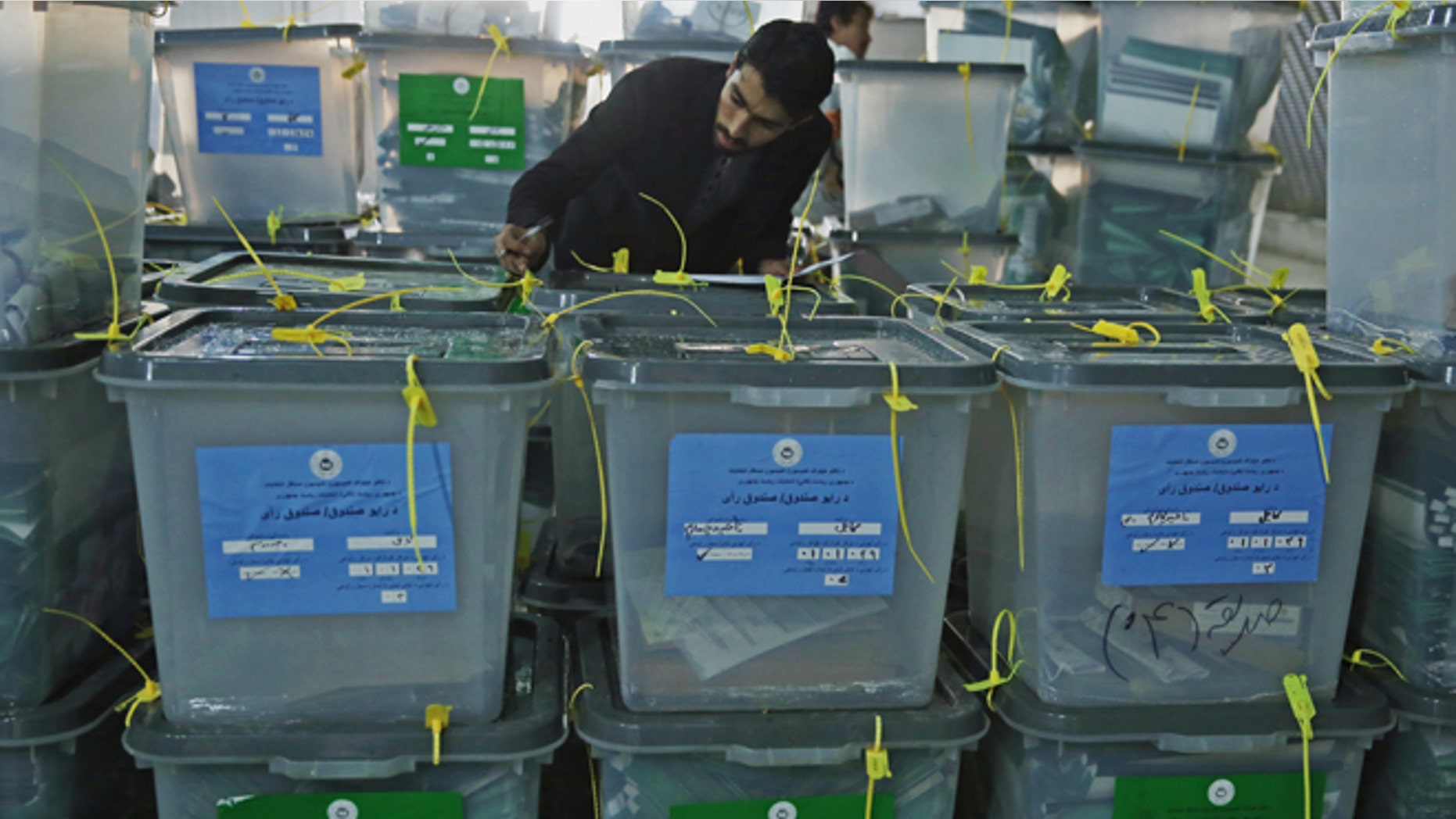 April 6, 2014: An Afghan elections worker notes the serial numbers of ballot boxes at a warehouse Independent Elections Commission in Kabul, Afghanistan.