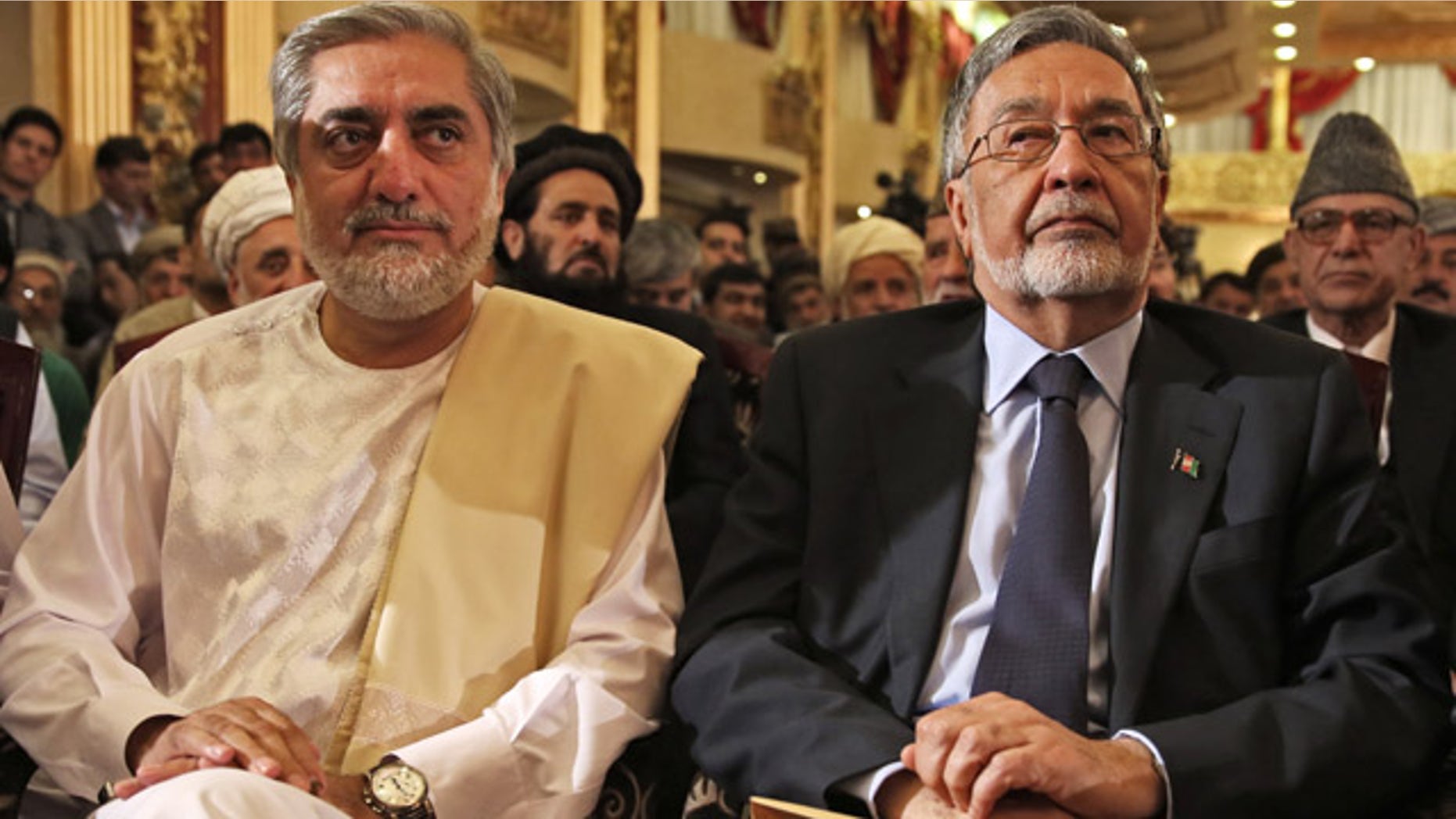 May 11, 2014: Afghan presidential candidate Abdullah Abdullah, left, and Afghan presidential candidate Zalmai Rassoul, right, listen during a news conference in Kabul, Afghanistan. (AP Photo/Massoud Hossaini)