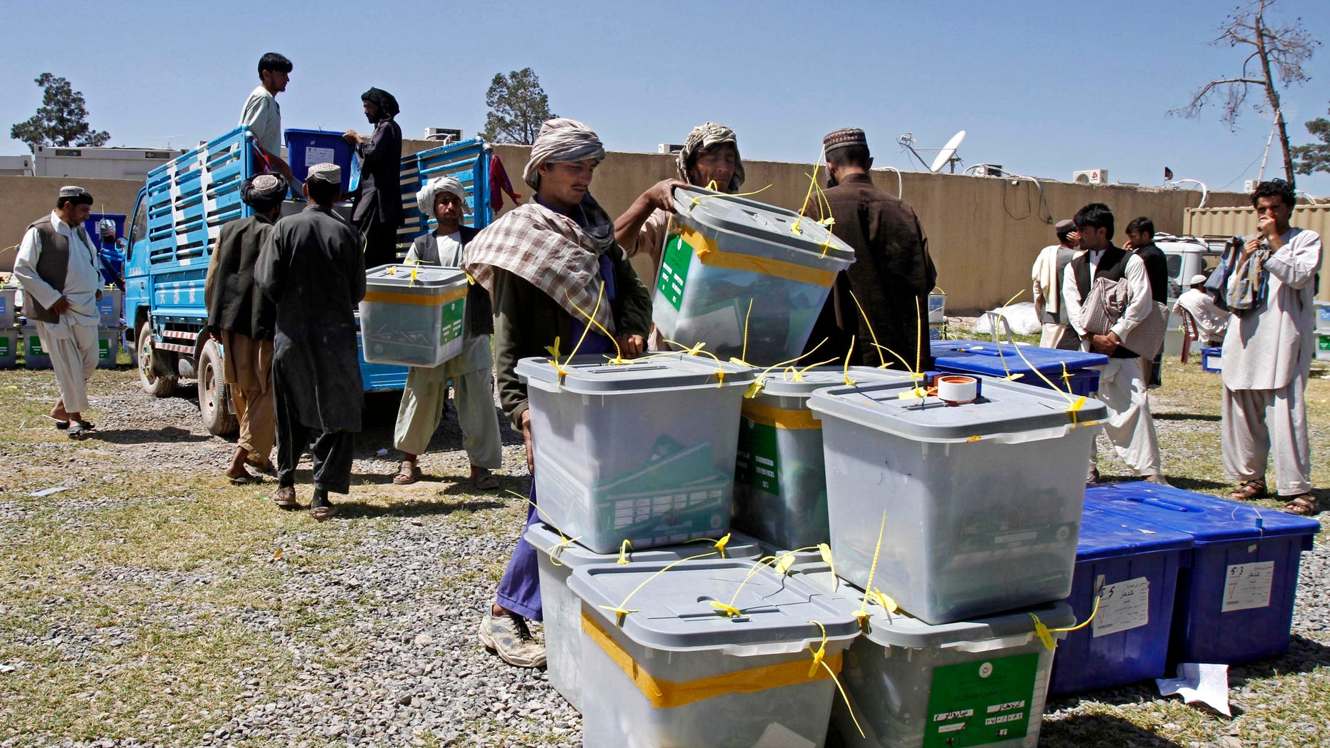 April 7, 2014 - Afghan election workers carry out a ballot box from a truck at the warehouse of the Independent Elections Commission in Kandahar, Afghanistan.