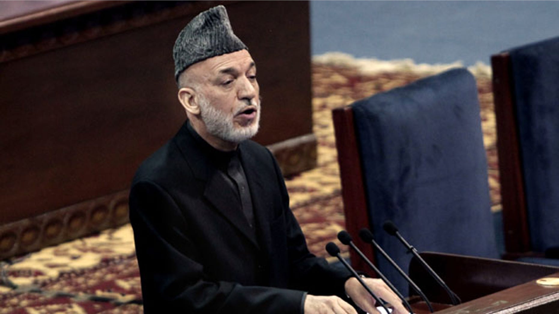 November 21, 2013: Afghan President Hamid Karzai speaks during the first day of the Loya Jirga in Kabul, Afghanistan. Karzai has told a gathering of elders that he supports signing a security deal with the United States if safety and security conditions are met. (AP Photo)