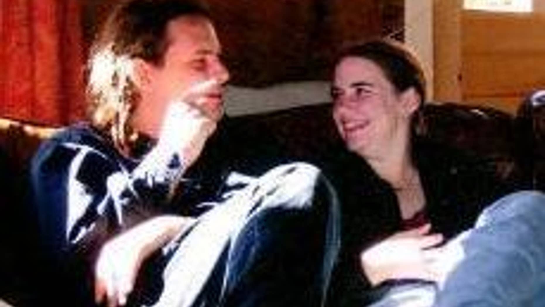 In this undated photo provided by James Coleman, Caitlan Coleman, right, sits with her husband, Josh. Caitlan Coleman's family has broken months of silence over her mysterious disappearance.