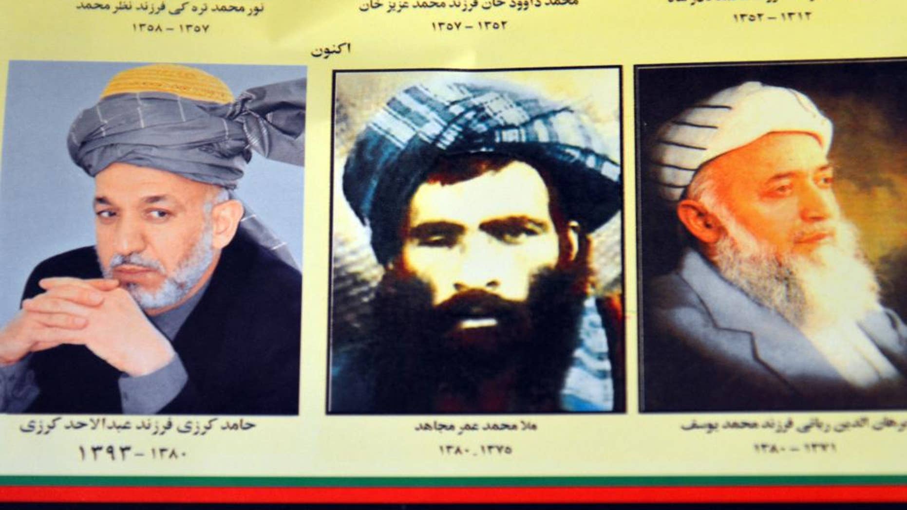 FILE - In this Thursday, July 30, 2015. file photo, an Afghan shop clerk shows a calendar with pictures of Afghan leaders including Mullah Mohammad Omar, center, in Kandahar, south of Kabul, Afghanistan. The new leader of the Afghan Taliban faces the challenge of bringing together an insurgency that he ran under another’s name and uniting a fractured movement that has seen fighters desert for more extreme groups such as the Islamic State. For its part, the Afghan government believes it can seize the on the crisis it has created by announcing that Mullah Mohammad Omar has been dead for more than two years ago to further weaken the insurgency by exposing the lie that had been holding it together. (AP Photo/Barialai Khoshhal, File)