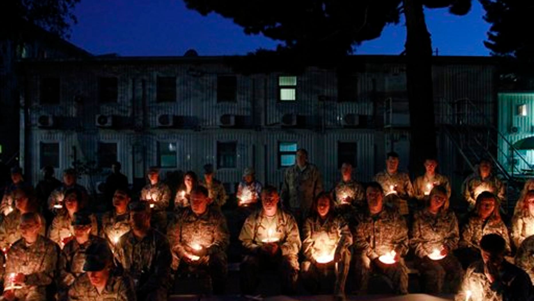 May 29: U.S. soldiers holds candles to mark the Memorial Day at the U.S. Army Corps of Engineers' headquarters in Kabul, Afghanistan. Some U.S. troops in Afghanistan have held a candlelit remembrance for those lost ahead of Memorial Day. (AP)