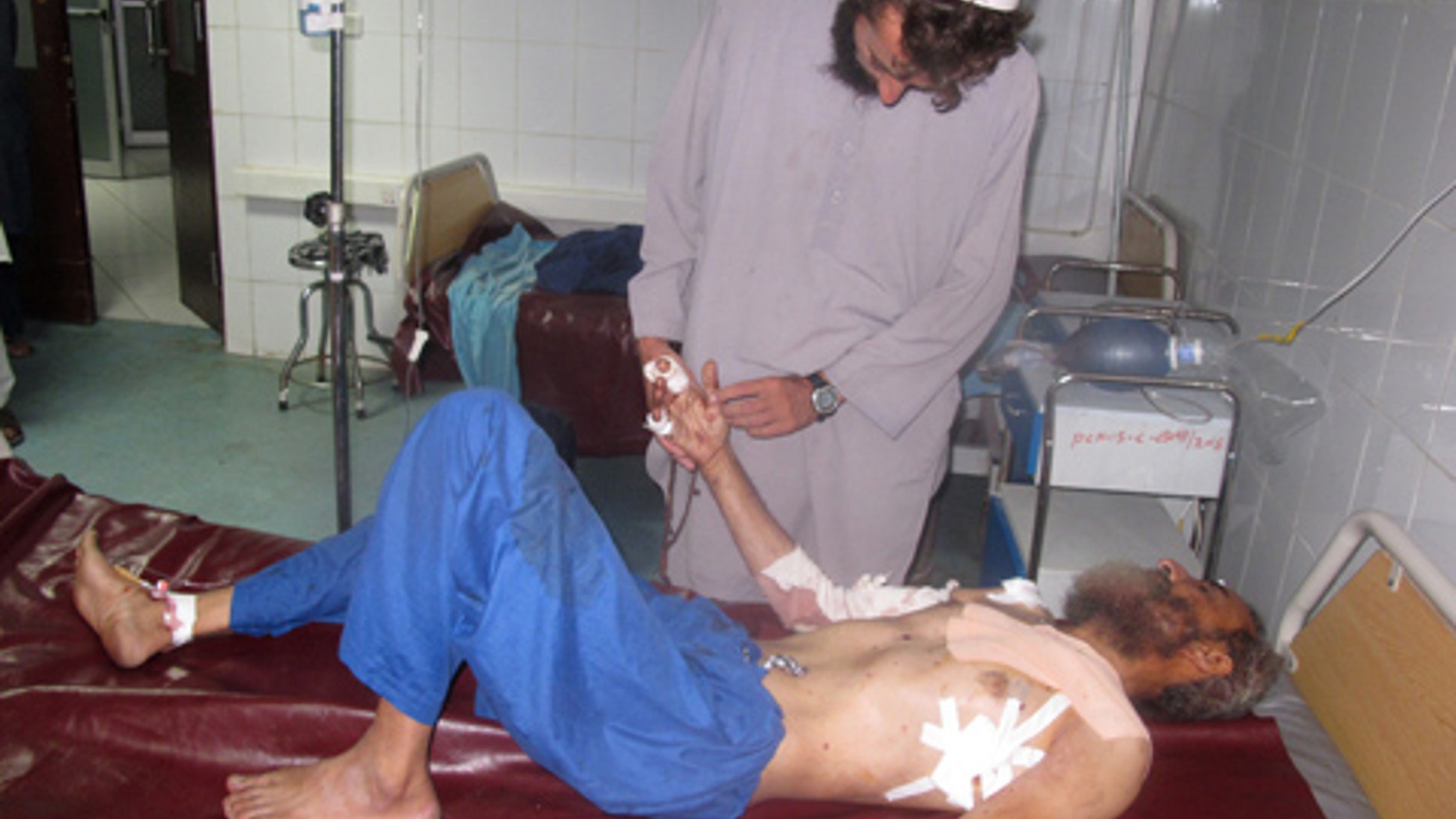 July 13, 2015: An Afghan man lies on a bed at a hospital after being injured at a suicide attack at Khost province eastern of Kabul. (AP Photo/Nishanuddin Khan)