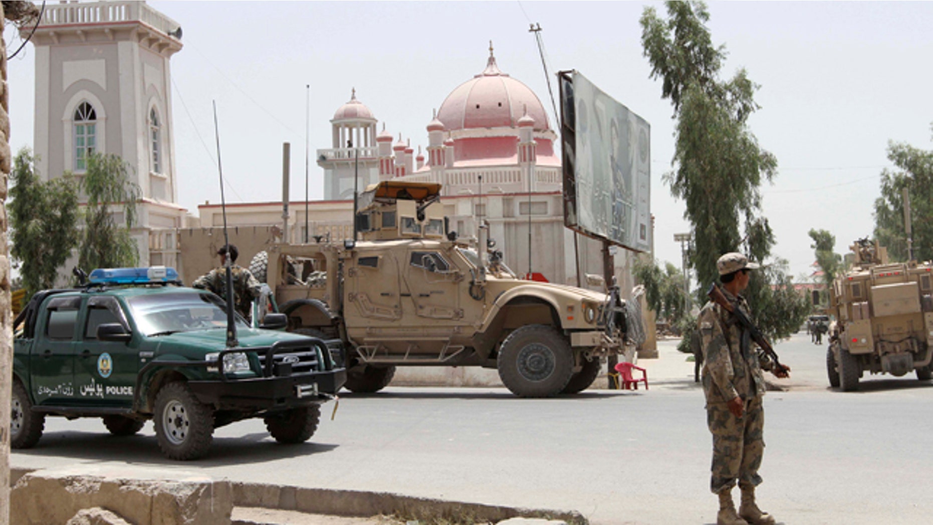 July 14: Afghan and U.S forces stand outside the mosque after a suicide attack in Kandahar, Afghanistan.