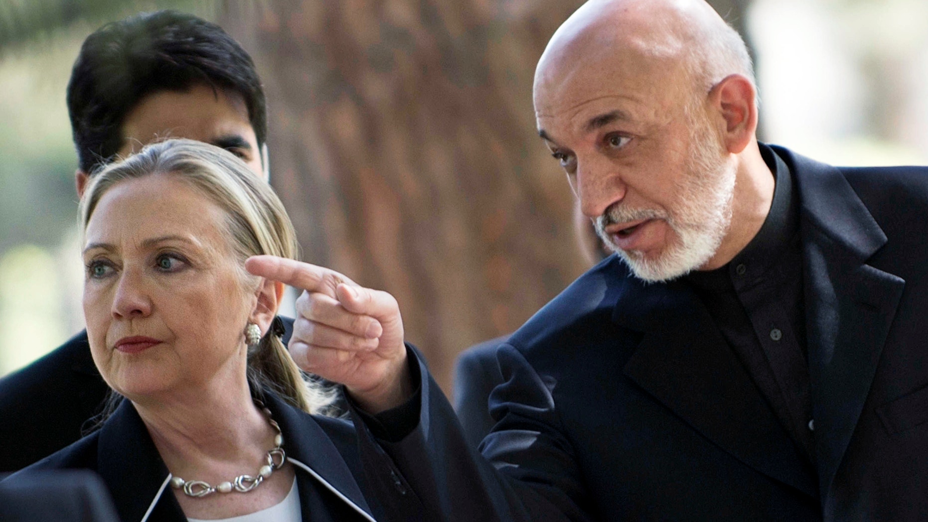 July 7, 2012: U.S. Secretary of State Hillary Rodham Clinton, left, walks with Afghanistan President Hamid Karzai to a news conference at the Presidential Palace in Kabul.