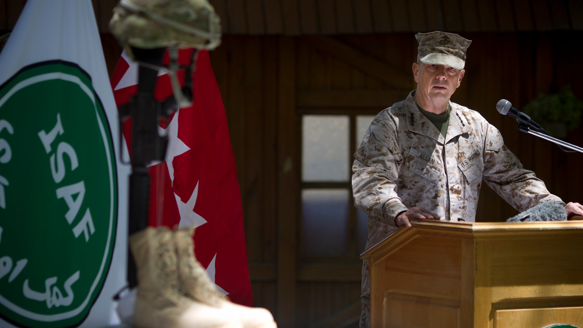 May 28, 2012: Gen. John Allen, the top U.S. commander in Afghanistan, observes Memorial Day by reading a letter written by an American soldier to his family before he died earlier this year, at the ISAF headquarters in Kabul, Afghanistan.