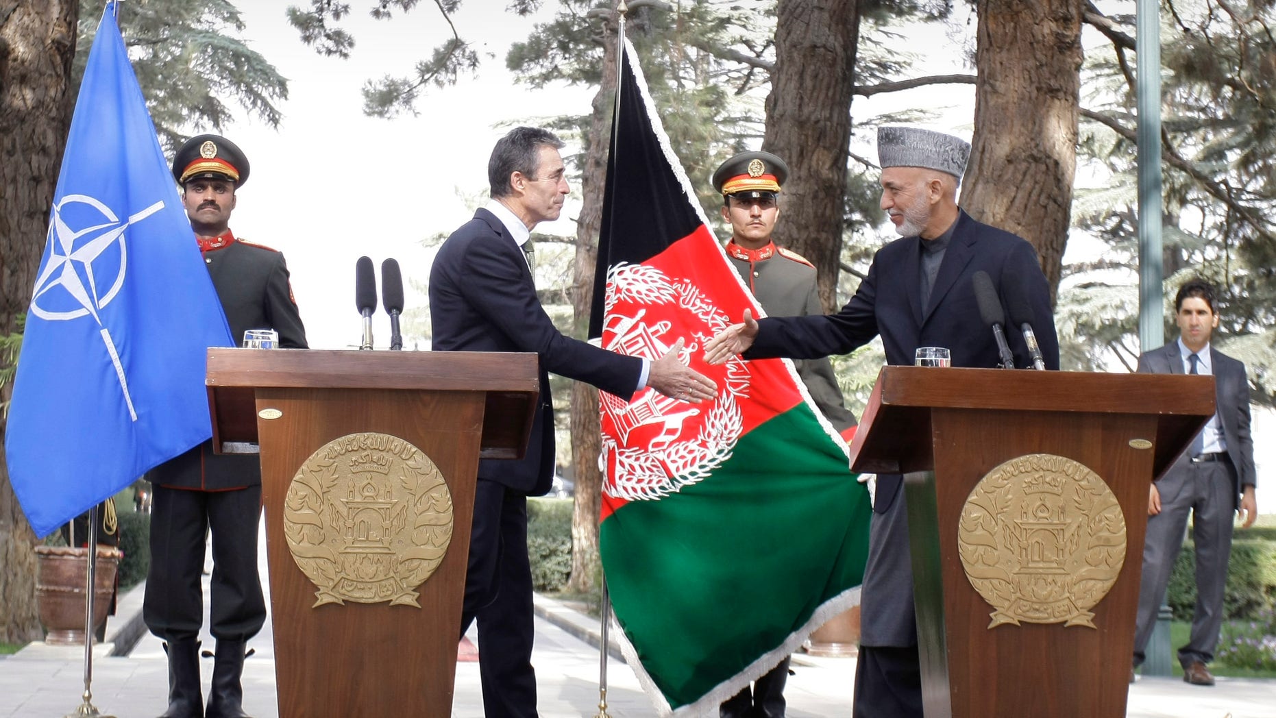 Afghan President Hamid Karzai, right, shakes hands with NATO's Secretary General Anders Fogh Rasmussen after a joint press conference at the presidential palace in Kabul, Afghanistan, Thursday, Oct. 18, 2012. NATO's top official said Thursday the alliance remains committed to help enable Afghan forces assume full responsibility for the country's security after 2014, when coalition troops are due to end their combat mission. (AP Photo/Musadeq Sadeq)