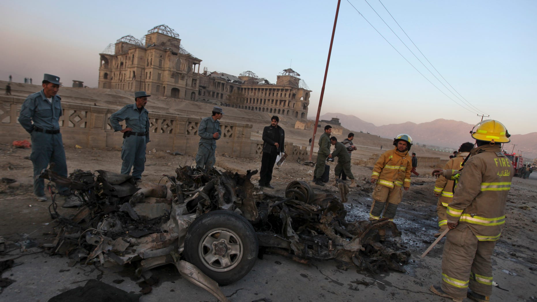 Nov. 12, 2010: Afghan police officers inspect the remains of a vehicle used by a suicide bomber at the site on an explosion on the outskirts of Kabul, Afghanistan.