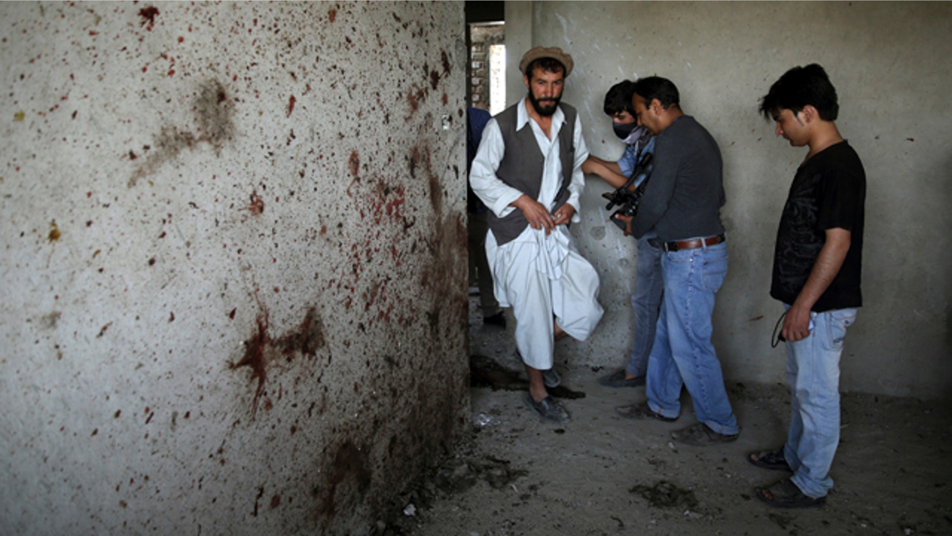 July 17, 2014: An Afghan man, left, enters a room which Taliban fighters used during a clash with Afghanistan's forces in Kabul. Gunmen launched a pre-dawn attack on the Kabul International Airport in the Afghan capital on Thursday, raining down rockets on the sprawling facility, setting off a gun battle with security forces and forcing the airport to close, officials said. (AP Photo/Massoud Hossaini)