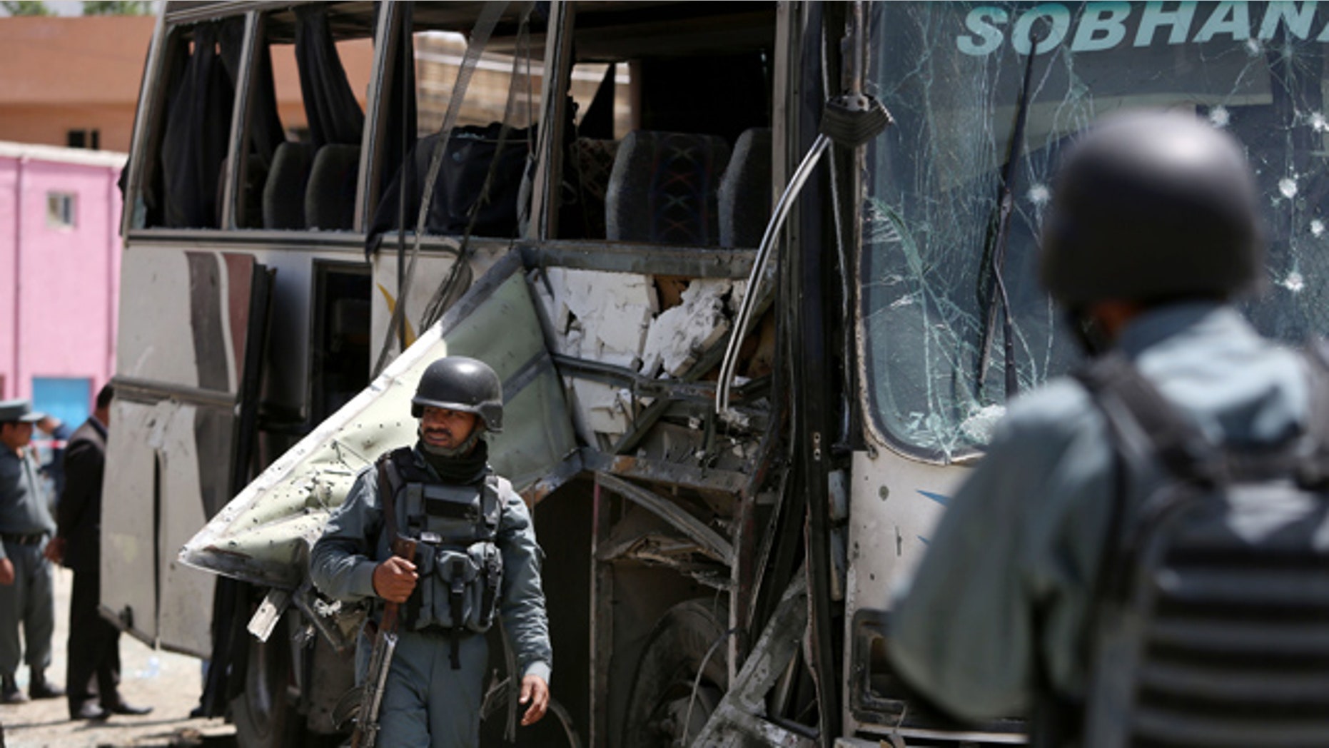 May 4, 2015: Afghan security forces inspect the site of a suicide attack in Kabul. An Afghan official says a suicide bomber struck a minibus carrying government employees in Kabul, killing at least one person and wounding more than a dozen. (AP Photo/Rahmat Gul)