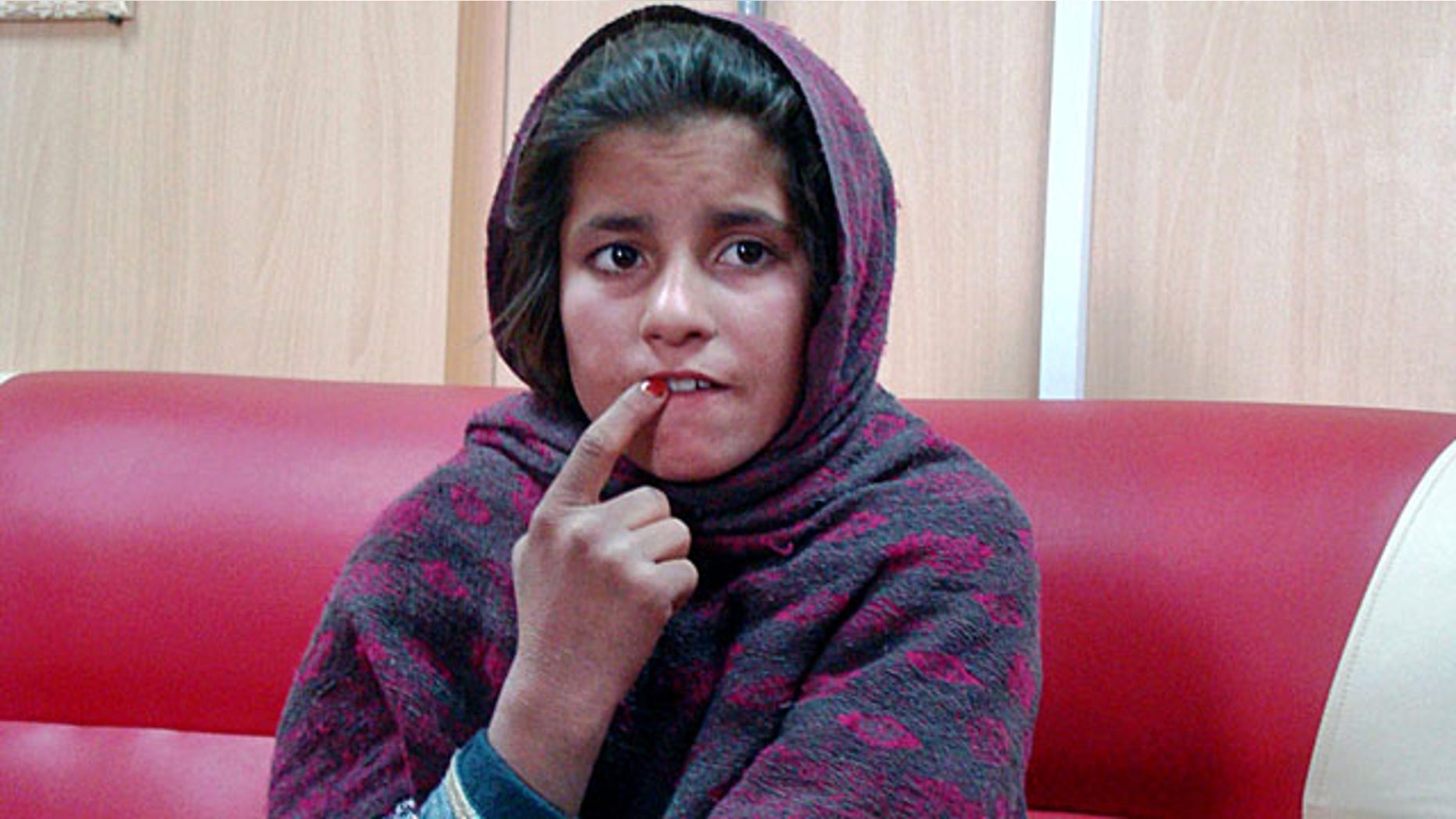 January 6, 2014: An Afghan girl named Spozhmai is held in a border police station in the Khan Neshin district in the southeastern part of Helmand province, Afghanistan. The 10-year-old told police that her brother, who she said is a Taliban commander, wrapped her in an explosives-packed vest but that she refused to blow herself up at a checkpoint in Helmand province. The Taliban denied the alleged plot. (AP Photo/Abdul Khaleq)