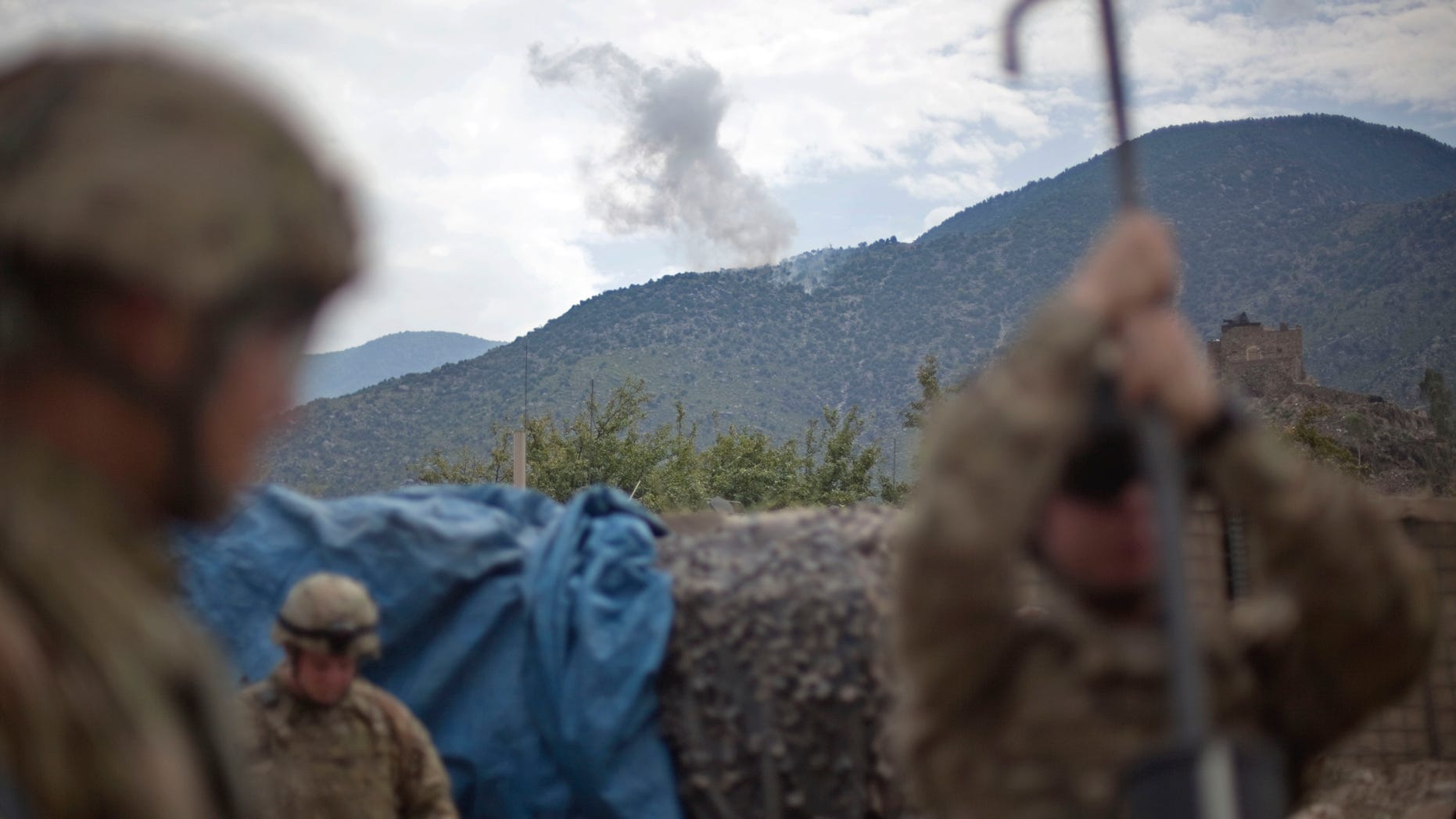 Smoke rises from an insurgent fighting position after being hit with a 120mm high explosive mortar round fired by soldiers with the U.S. Army's Bravo Company of the 25th Infantry Division, 3rd Brigade Combat Team, 2nd Battalion 27th Infantry Regiment based in Schofield Barracks, Hawaii, Friday, Sept. 9, 2011 at Combat Outpost Monti in Kunar province, Afghanistan.