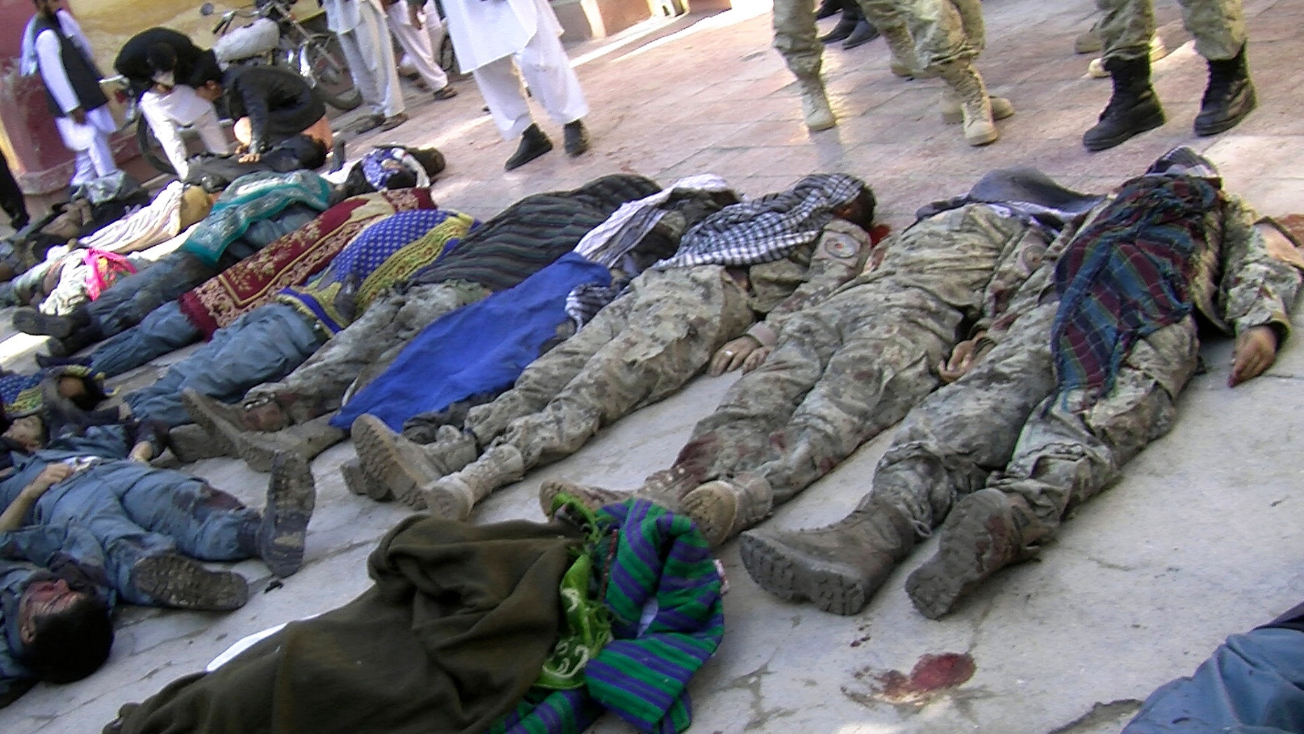 Oct. 26, 2012 - Bodies of victims of a suicide attack lie in a courtyard of a hospital in Maymana, northwest of Kabul, Afghanistan.