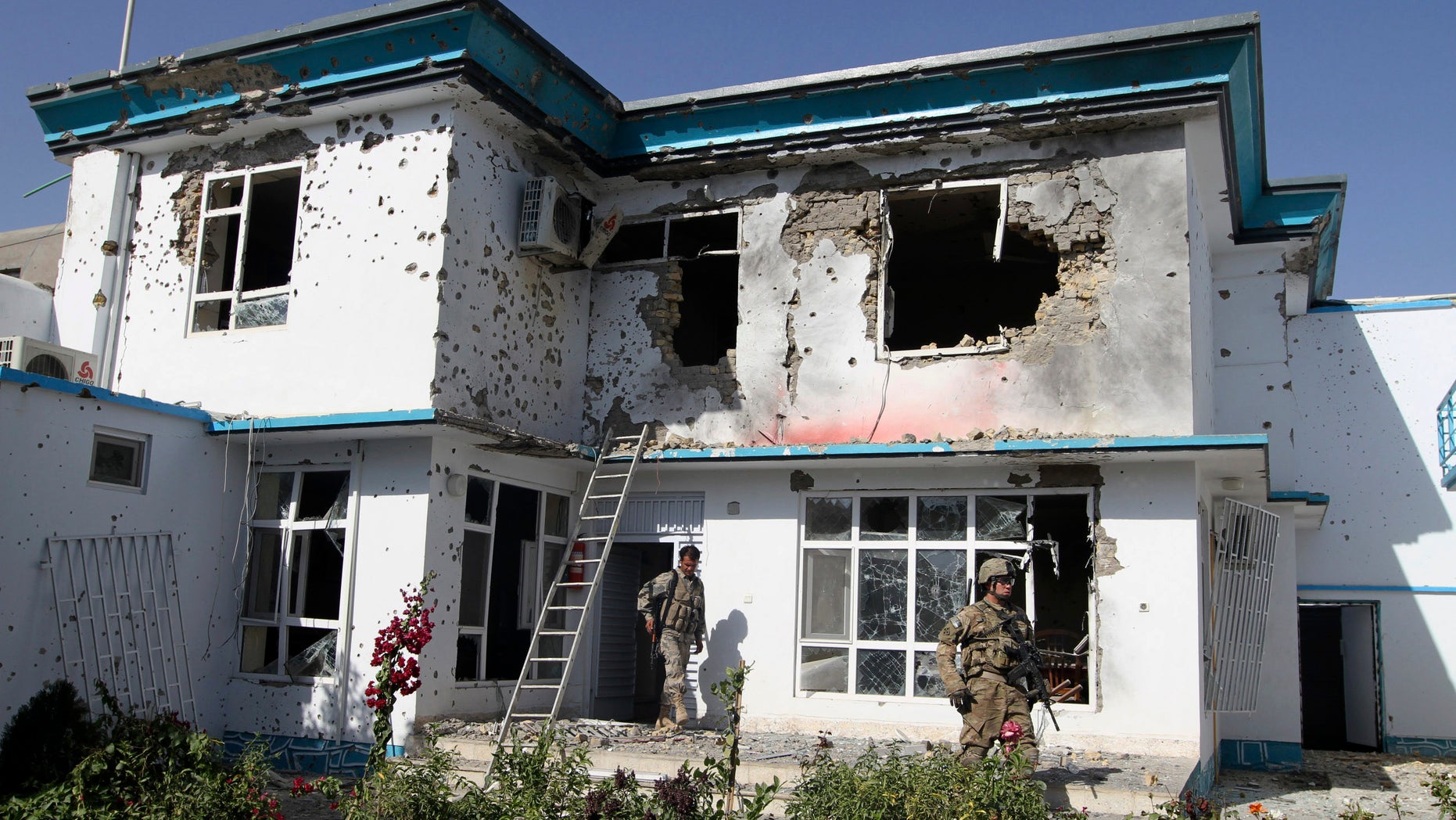 October 31: A US soldier and an Afghan security man, check the damage at offices of the U.N.'s refugee agency, the UNHCR, caused by a suicide bomber, in Kandahar, Afghanistan.