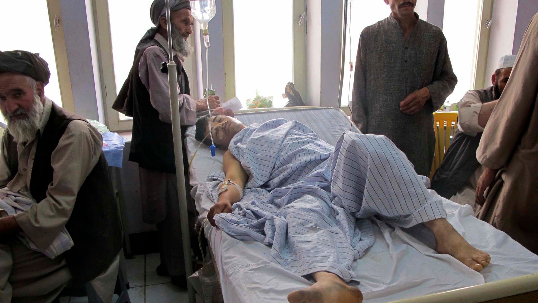 June 25: An injured Afghan man, a victim of a blast lies in a hospital bed in Kunduz city in the northern province of Kunduz, Afghanistan. A bicycle rigged with explosives ripped through a bazaar in the Khanabad district of Kunduz province on Friday, killing at least 10 people, including a police officer. At least 24 people were wounded in the attack, according to an Interior Ministry statement.