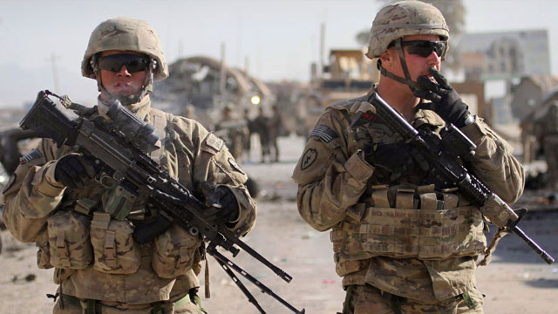 Jan. 19, 2012: U.S. soldiers with the NATO led International Security Assistance Force (ISAF) stand guard at the scene of a suicide attack in Kandahar south of Kabul, Afghanistan.