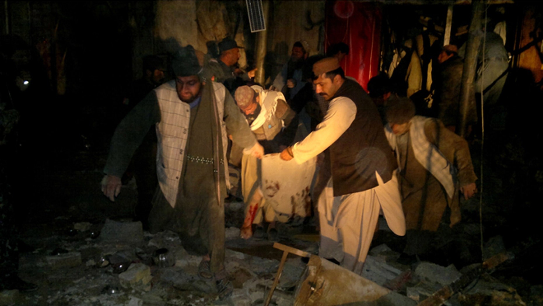 Feb. 25, 2014: Afghans carry the dead body of a civilian after a suicide attack in Trin Kot, capital of Uruzgan province, Afghanistan.