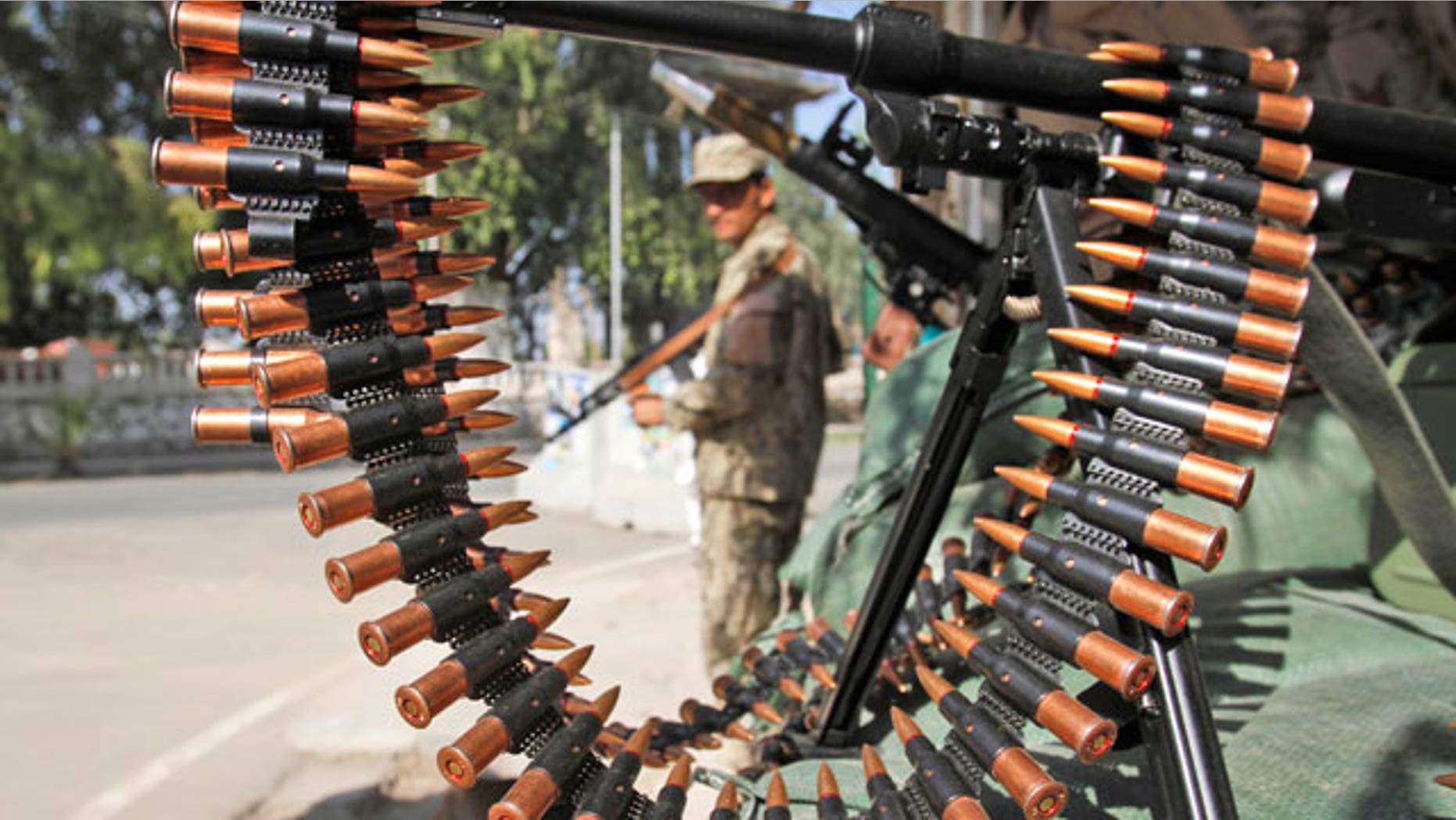 Oct. 18, 2011: An Afghan policeman stands guard at a checkpoint in Jalalabad, Afghanistan.