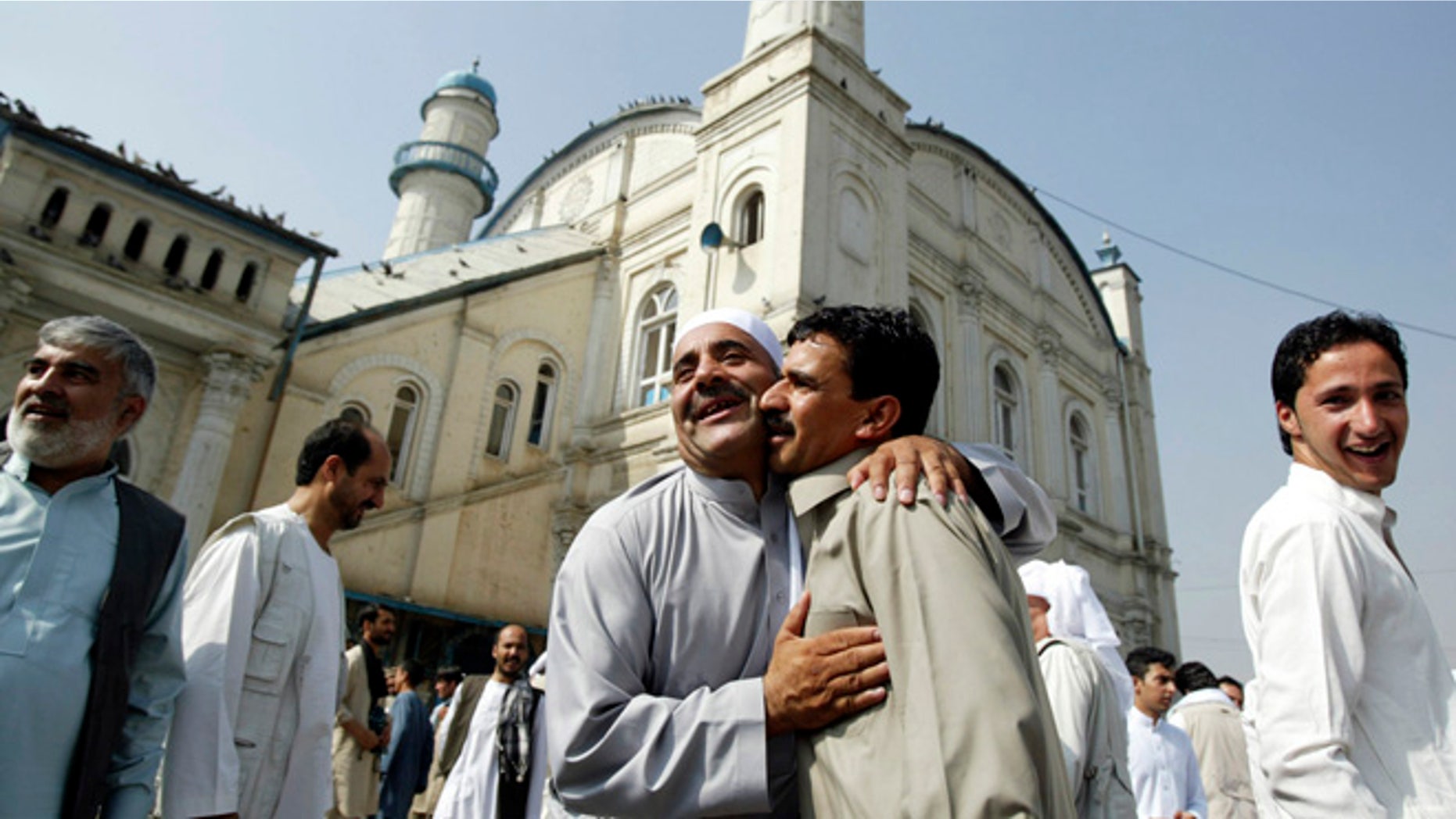 Aug. 8, 2013: Afghans celebrate the Eid al Adha each other after offering Eid al Adha's prayers outside Shah-e-Dushamshera mosque in Kabul, Afghanistan.