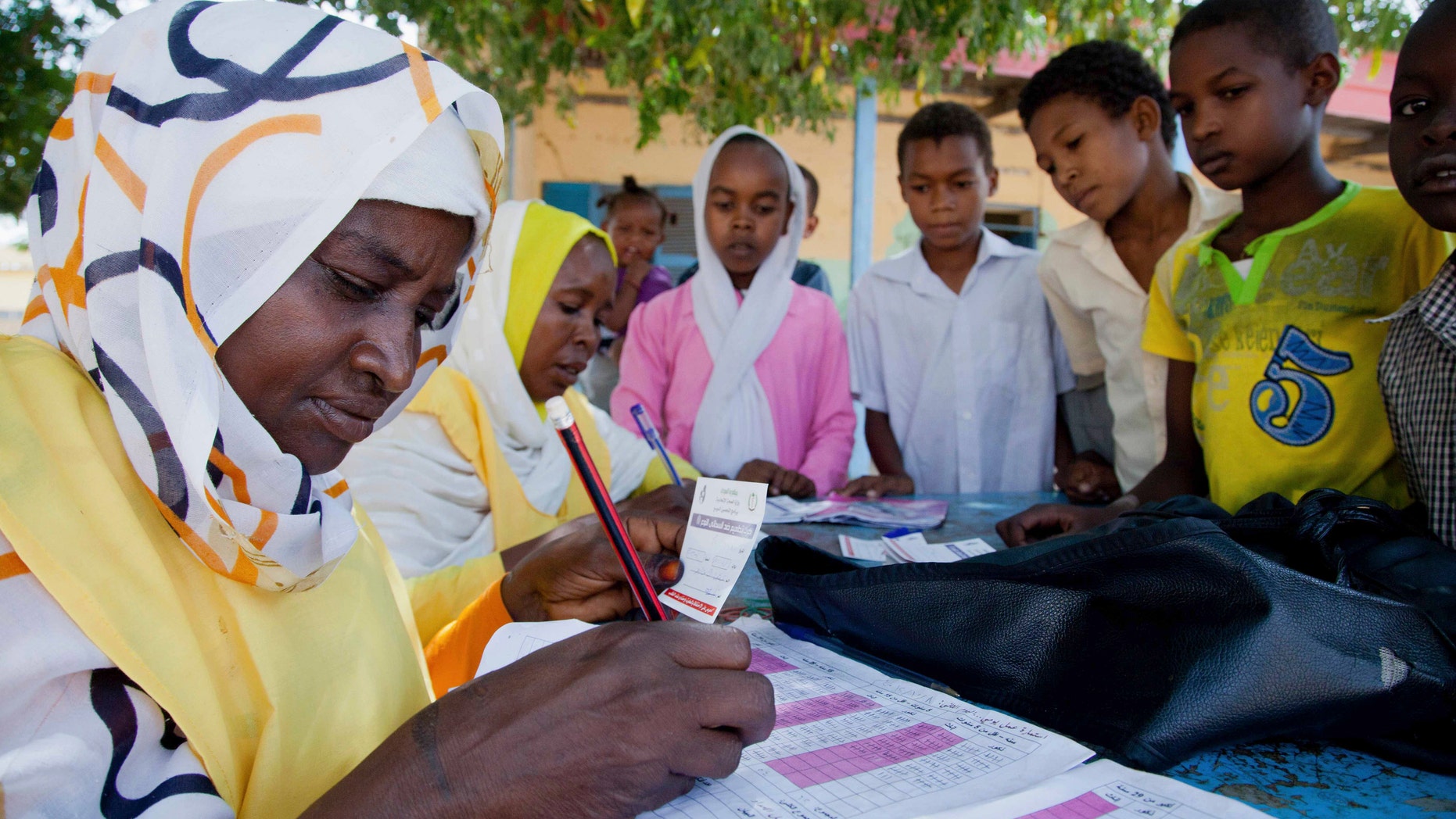 Children register for a meningitis vaccination at the School for Midwives in El Daein, East Darfur.