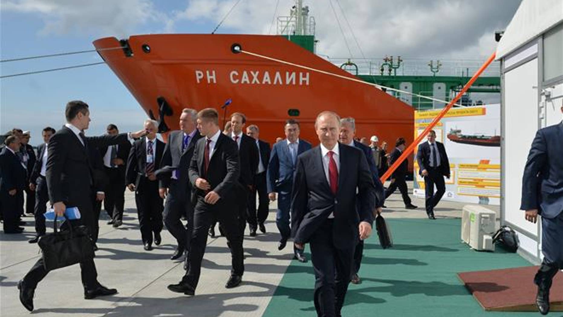 Russian President Vladimir Putin, foregound, walks in the Far Eastern port of Bolshoi Kamen, Russia, on Sept. 1, 2016.