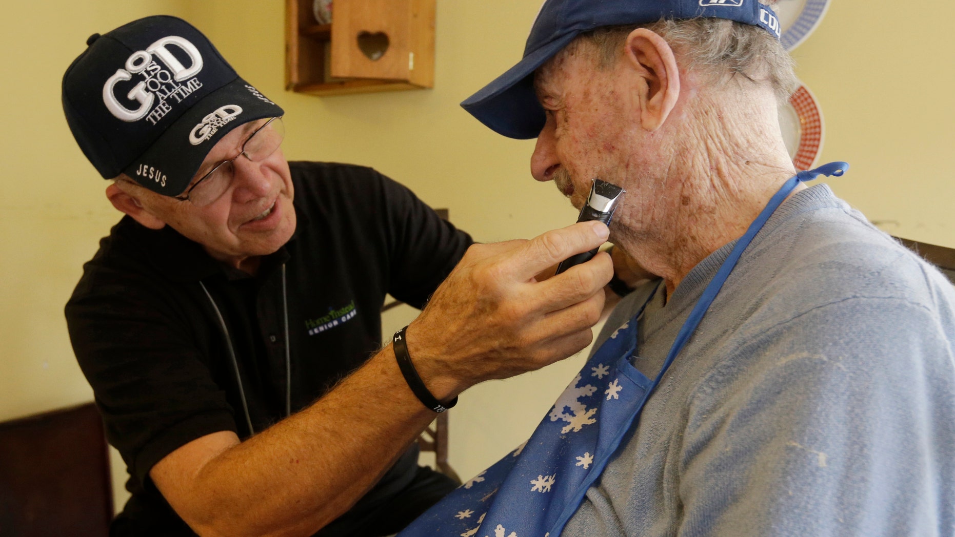 Caregiver Warren Manchess, 74, left, shaves Paul Gregoline, in Noblesville, Ind. (AP Photo/Darron Cummings)