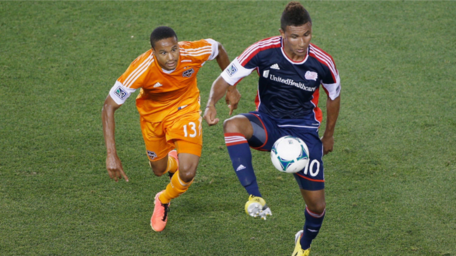 HOUSTON, TX - MAY 18: Juan Agudelo #10 of the New England Revolution plays a ball in the second half against Ricardo Clark #13 of the Houston Dynamo at BBVA Compass Stadium on May 18, 2013 in Houston, Texas. (Photo by Scott Halleran/Getty Images)