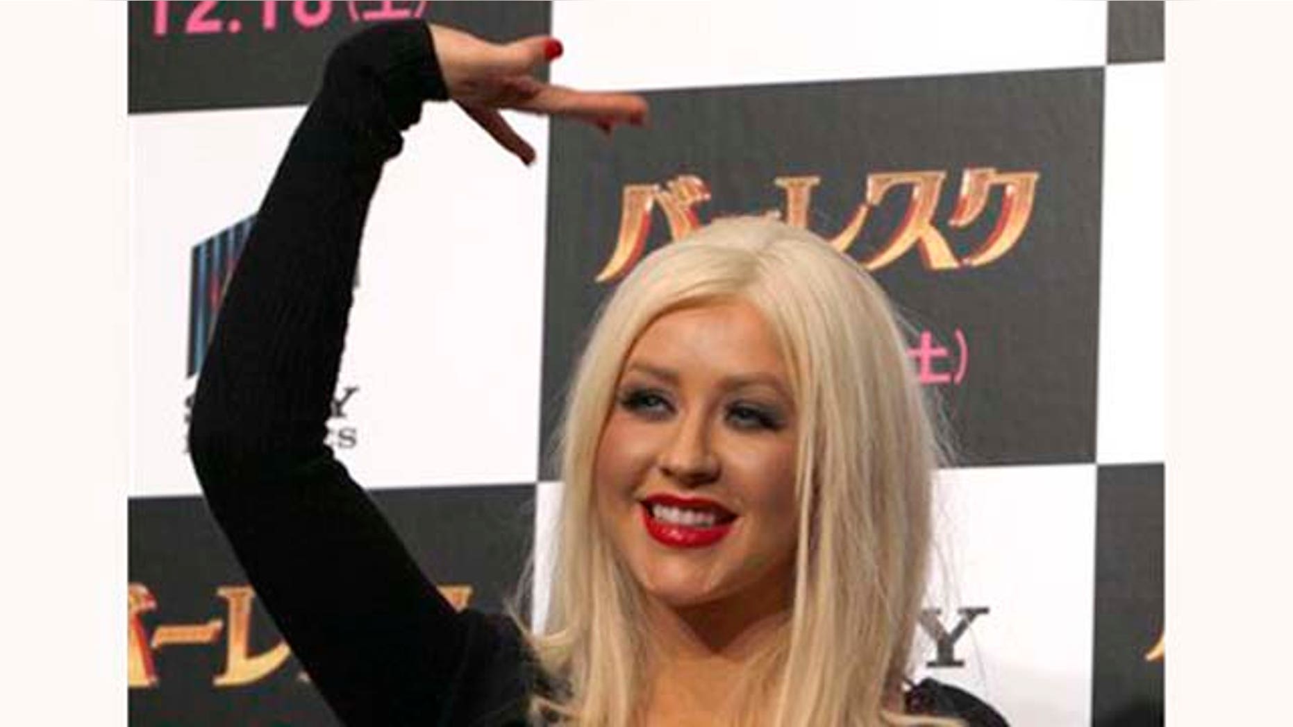 Actress Christina Aguilera waves during a press conference of their movie of "Burlesque" in Tokyo, Japan, Monday, Dec. 6, 2010. (AP Photo/Shizuo Kambayashi)