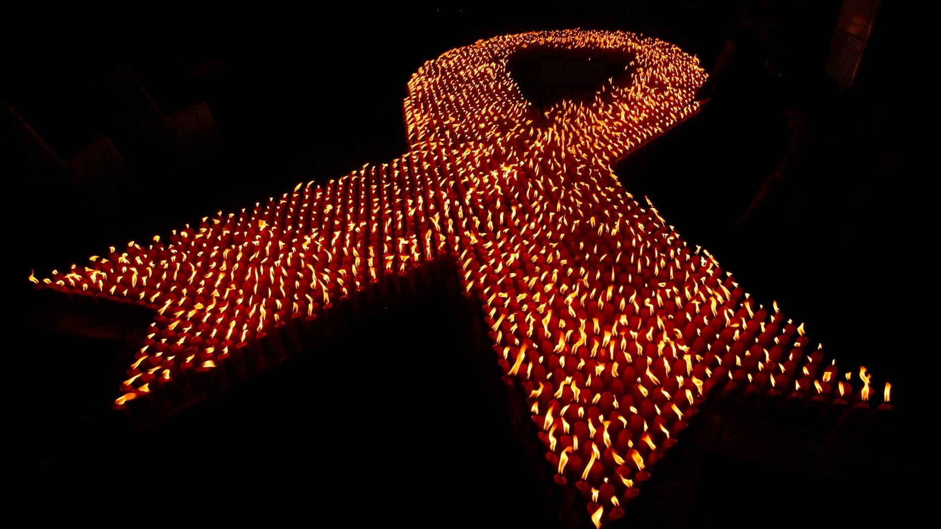 About 2,880 candles are seen lit during a World AIDS Day event December 1, 2009. (REUTERS/Dadang Tri)