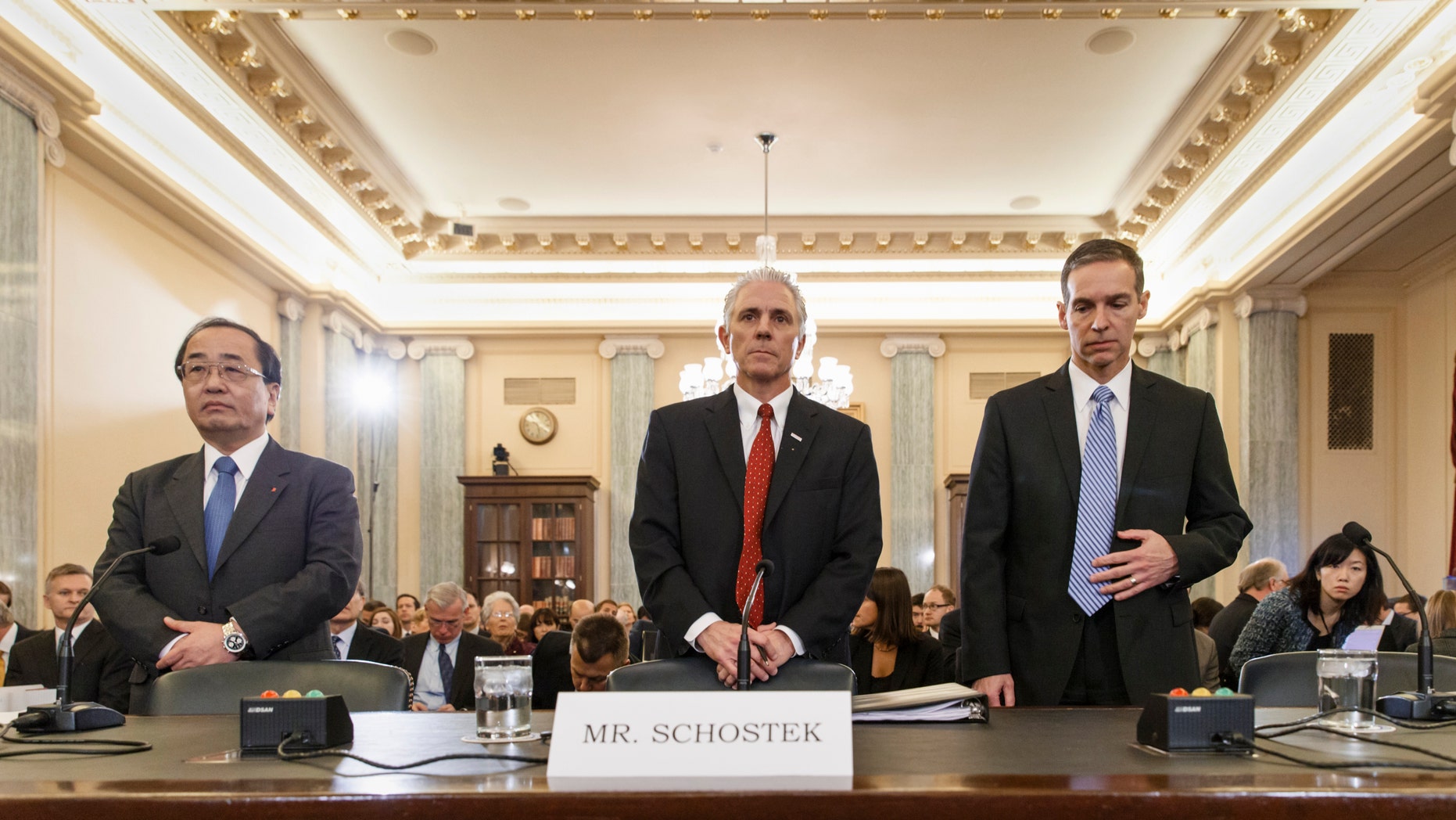 From left, Hiroshi Shimizu, senior vice president of global quality assurance at Japanese airbag maker Takata, Rick Schostek, executive vice president of Honda North America, and Scott Kunselman, Chrysler's senior vice president of vehicle safety and regulatory compliance, take their seats on Capitol Hill in Washington, Thursday, Nov. 20, 2014, prior to testifying before the Senate Commerce Committee hearing on airbags linked to multiple deaths and injuries in cars driven in the US. (AP Photo/J. Scott Applewhite)