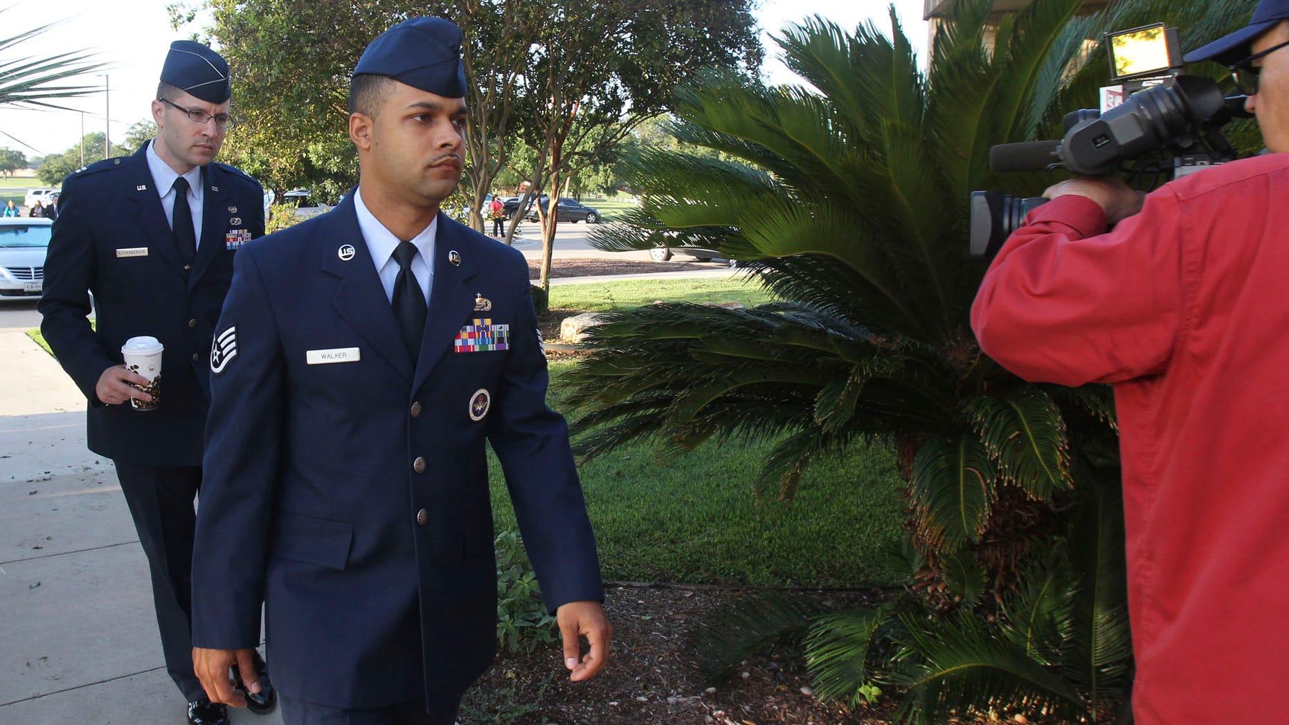 July 20, 2012: Air Force Staff Sgt. Luis Walker, left foreground, arrives for the fourth day of his trial at Lackland Air Force Base in San Antonio, Texas.