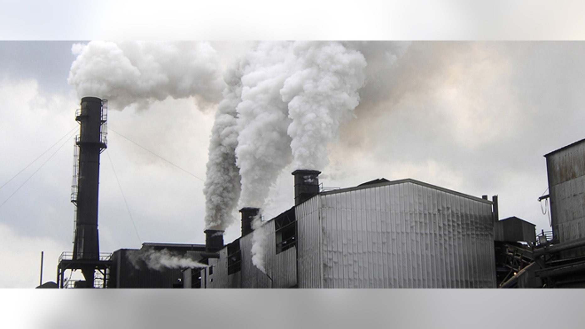 Smoke rises from the smoke stacks in the foreground from The Bryant Sugar House on Tuesday, April 10, 2007 in Pahokee, Fla. Faced with growing pressure from free trade, U.S. Sugar Corp., the nation's largest producer of cane sugar, is shuttering the plant, moving operations to another more high-tech mill about 30 miles away. (AP Photo/Steve Mitchell)