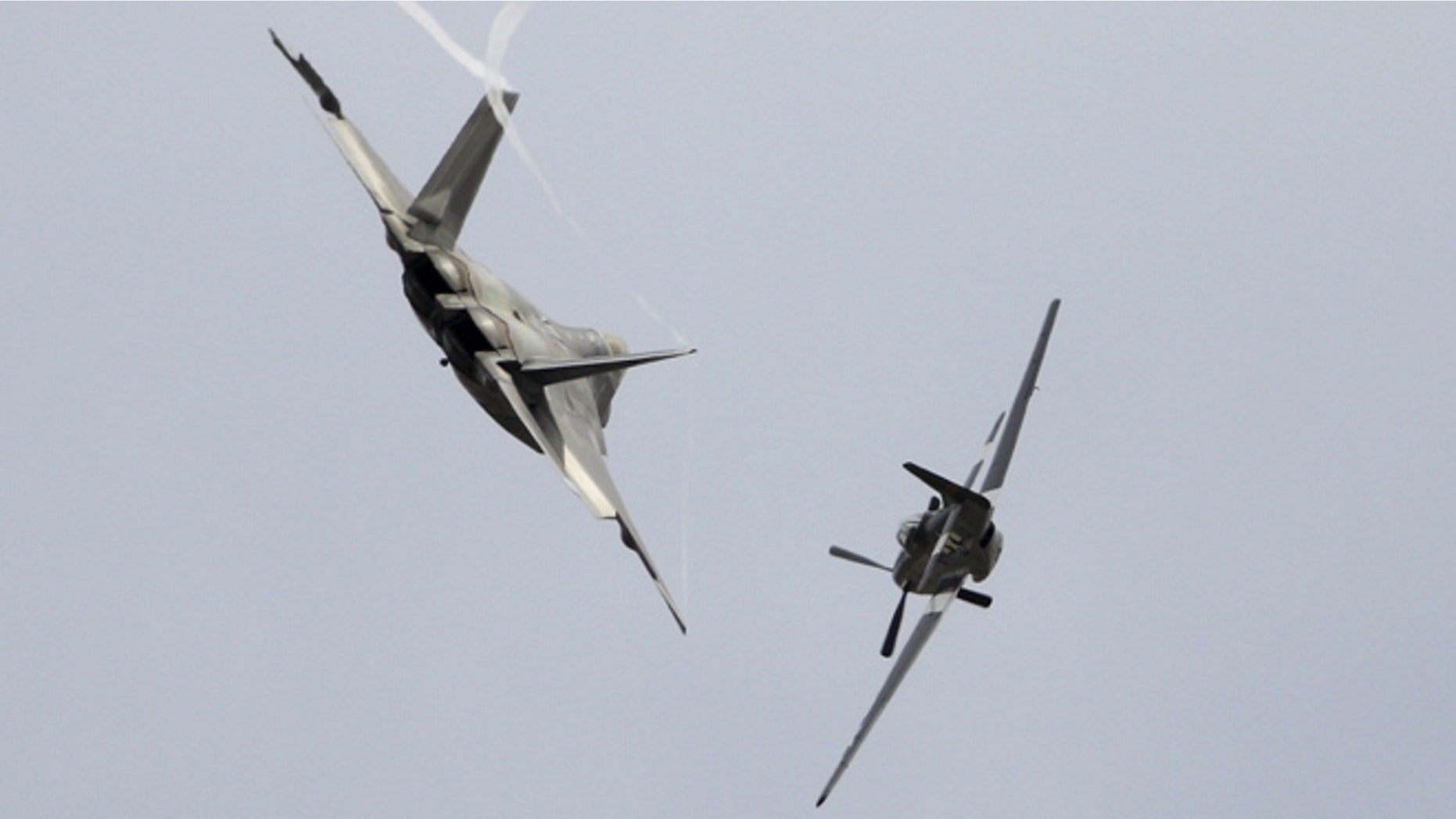 FILE: September 27, 2015: A U.S. Air Force P-51 Mustang and an F-22 Raptor fighter jet at the California International Airshow in Salinas, Calif.