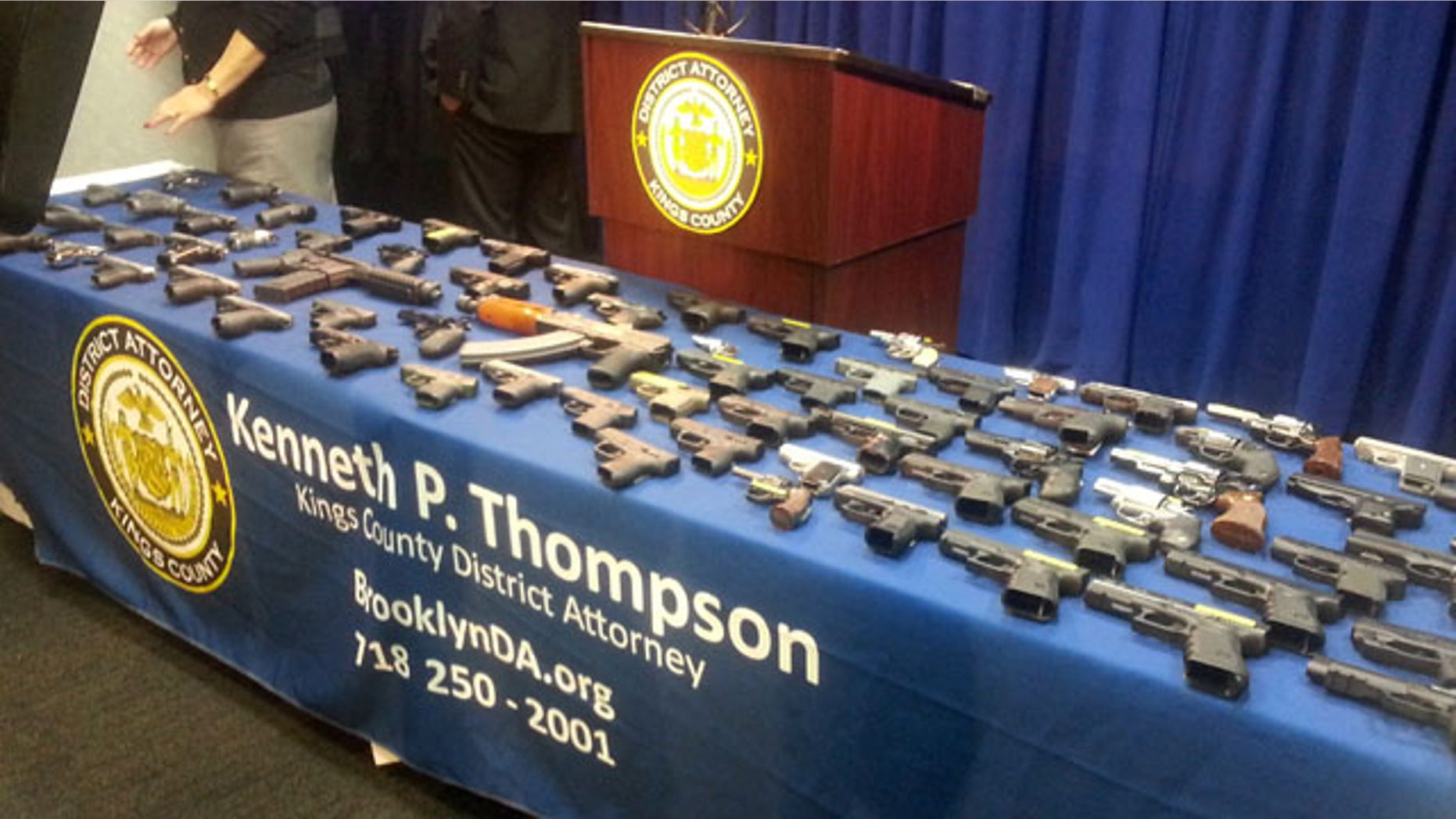 Dec. 23, 2014: In this photo provided by the Brooklyn District Attorney's Office, a collection of handguns and two assault rifles fill a table during a news conference. (AP Photo/Brooklyn District attorney's Office, Christina Carrega-Woodby)