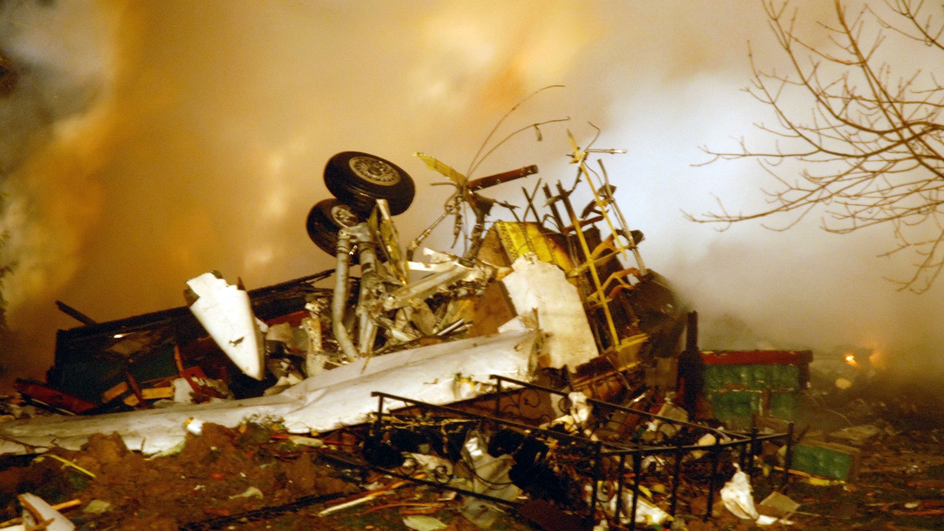 Feb. 12, 2009: In this file photo, the wreckage of Continental flight 3407 lies amid smoke at the scene after crashing into a suburban Buffalo home and erupting into flames, killing all 48 people aboard and at least one person on the ground, according to authorities.